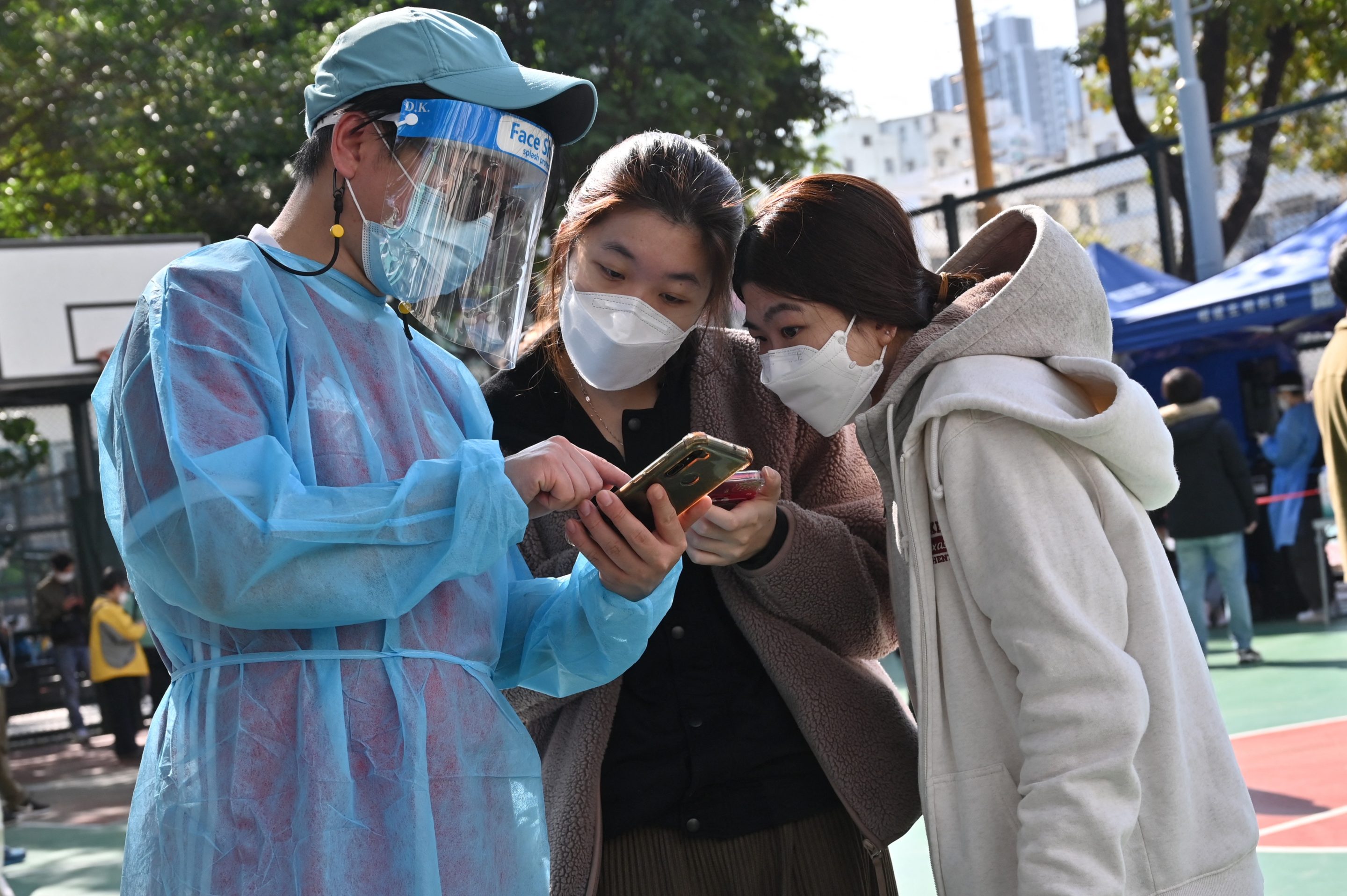 People check in at a COVID-19 testing center in Hong Kong on Feb. 25, 2022.
