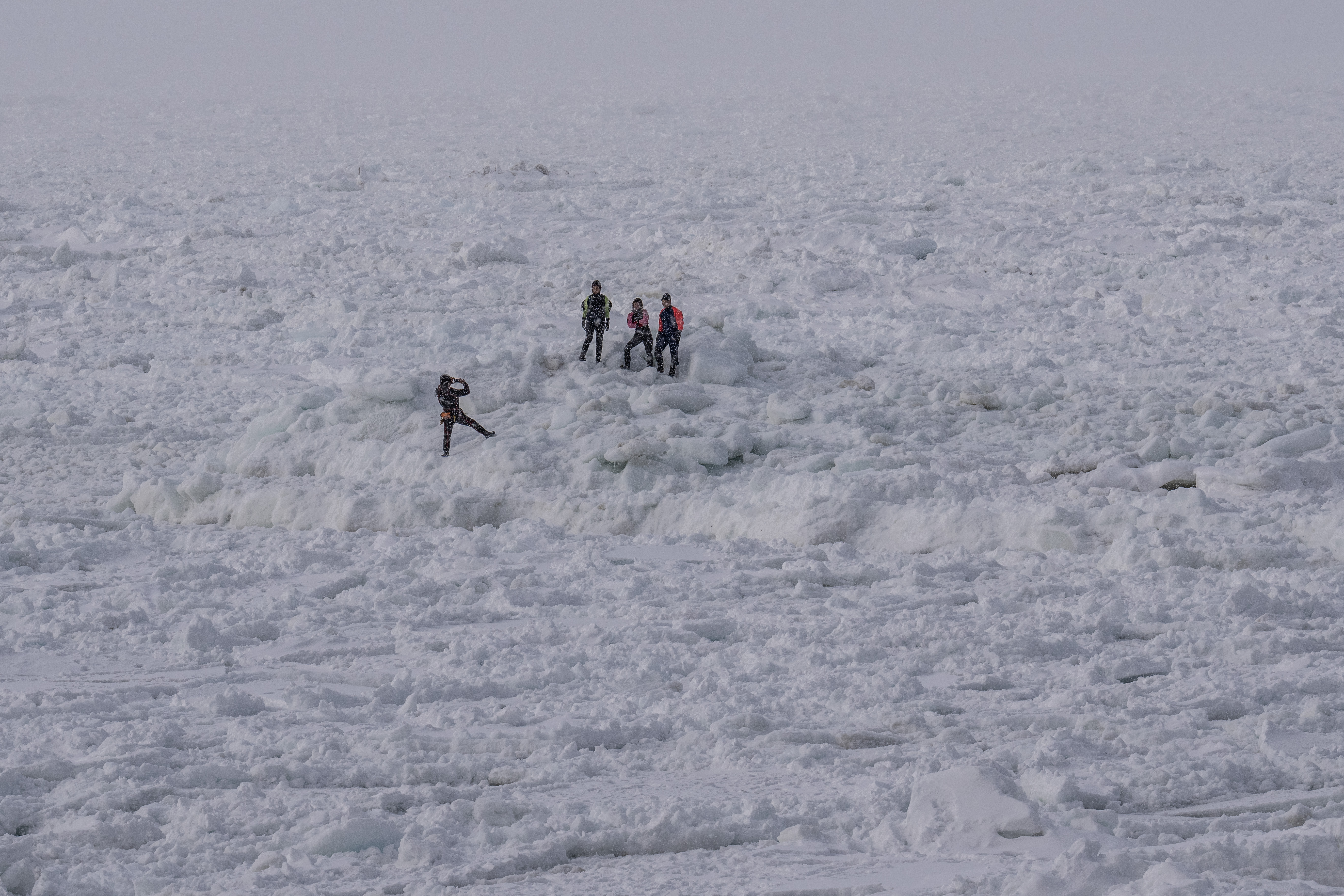 People on the drift ice covering the Sea of Okhotsk on February 24, 2022 in Shari, Japan. The temperature of the Sea of Okhotsk is believed to have increased by around two degrees over the last fifty years reducing the amount of drift ice by 30% in roughly the same period.