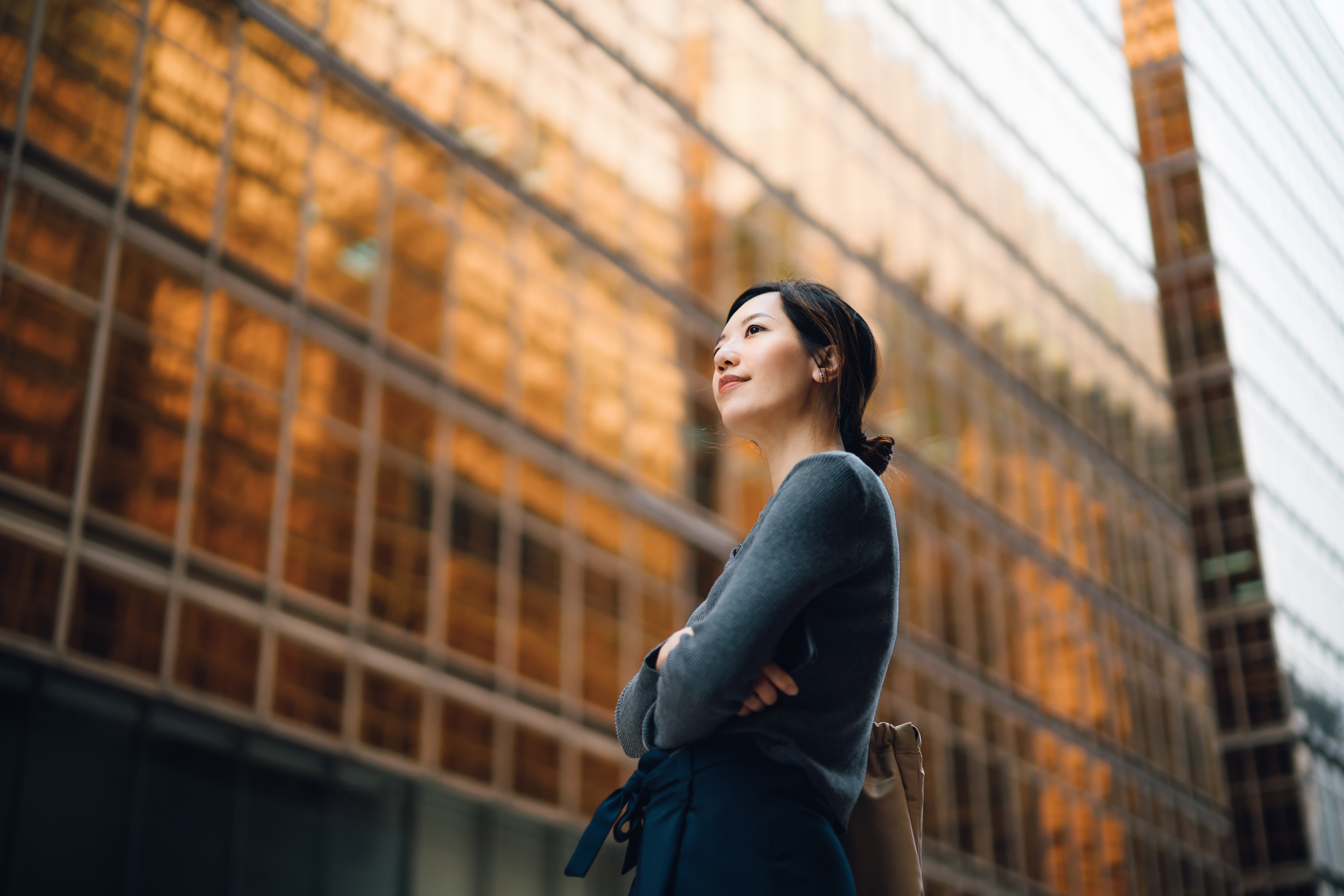 Businesswoman looking at corporate skyscraper