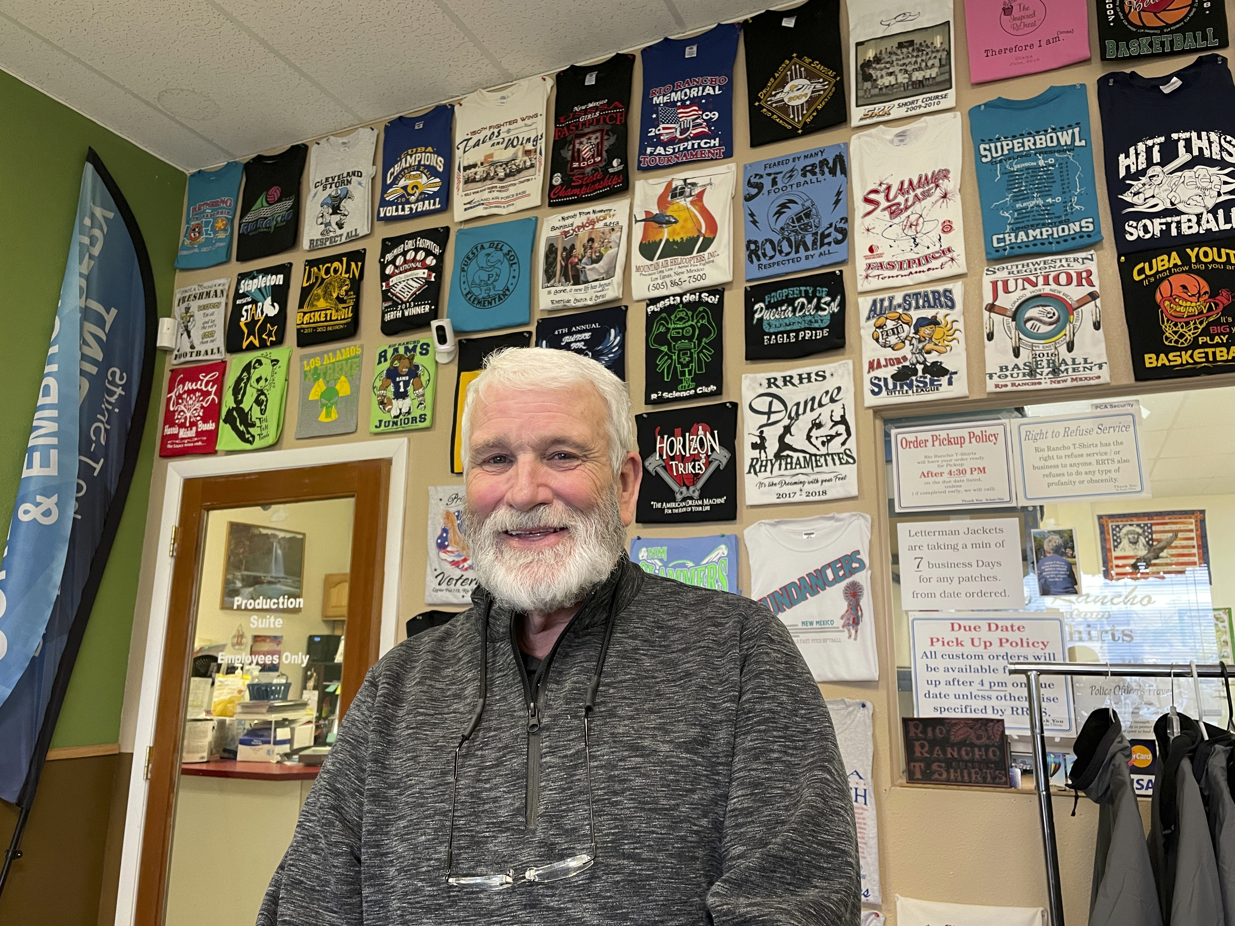 Wayne Holly, the owner of Rio Rancho T-Shirts, poses for a portrait at the family-owned shop in Rio Rancho, N.M., Monday, March 21, 2022. Holly said the small business he and his wife have operated for more than 20 years is feeling the pinch of inflation and that tax rebates offered by state governments won't be enough to combat rising prices or ongoing economic fallout from the coronavirus pandemic.