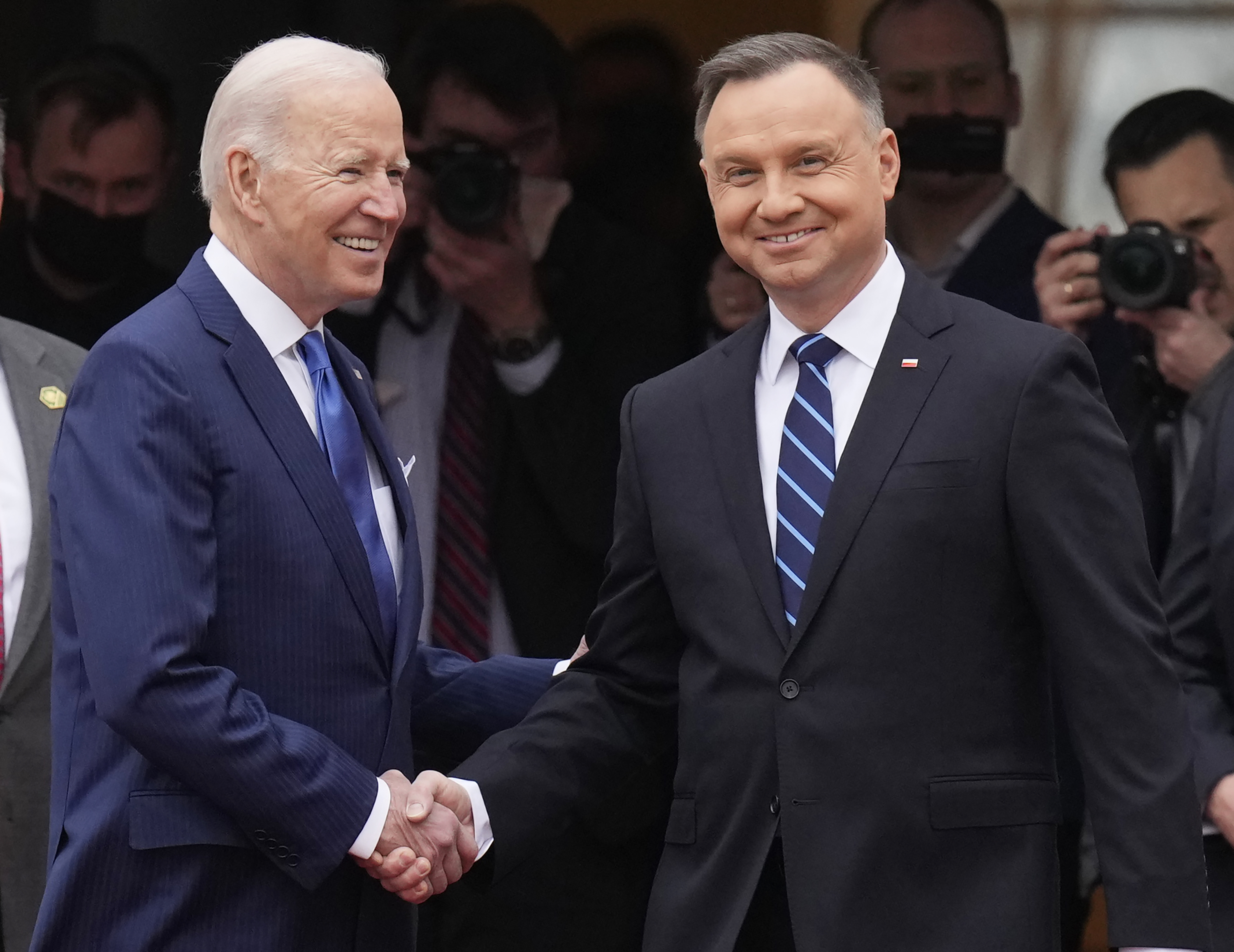 U.S. President Joe Biden, left, and Polish President Andrzej Duda shake hands during a military welcome ceremony at the Presidential Palace in Warsaw, Poland, on Saturday, March 26.