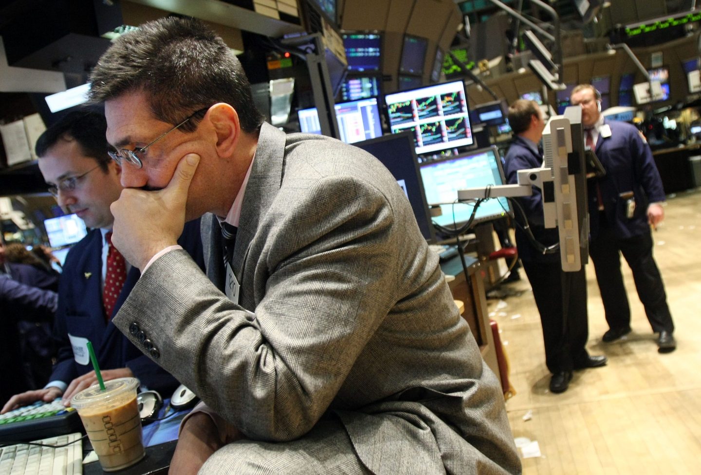 A trader on the New York Stock Exchange covers his mouth after a tough day during the Great Recession in 2007.