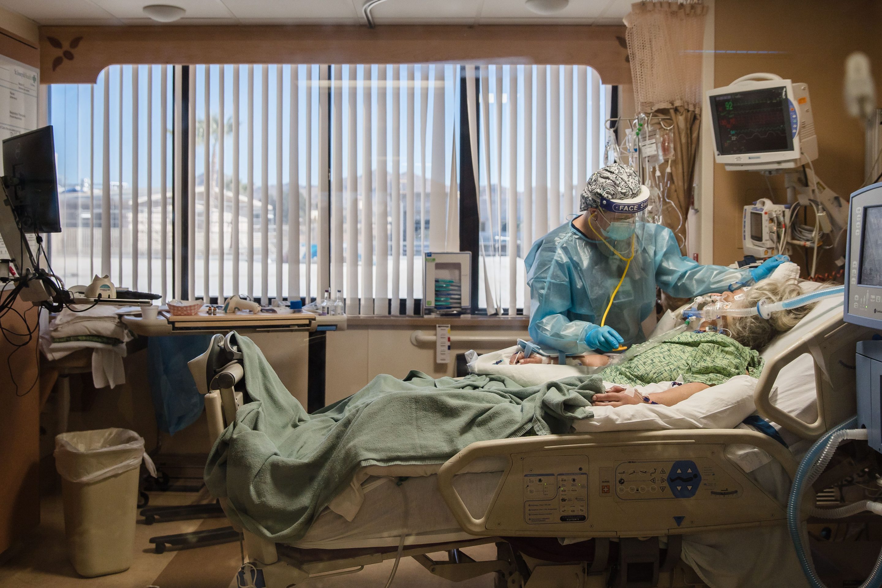 A Registered Nurse tends to a Covid-19 patient in the Intensive Care Unit