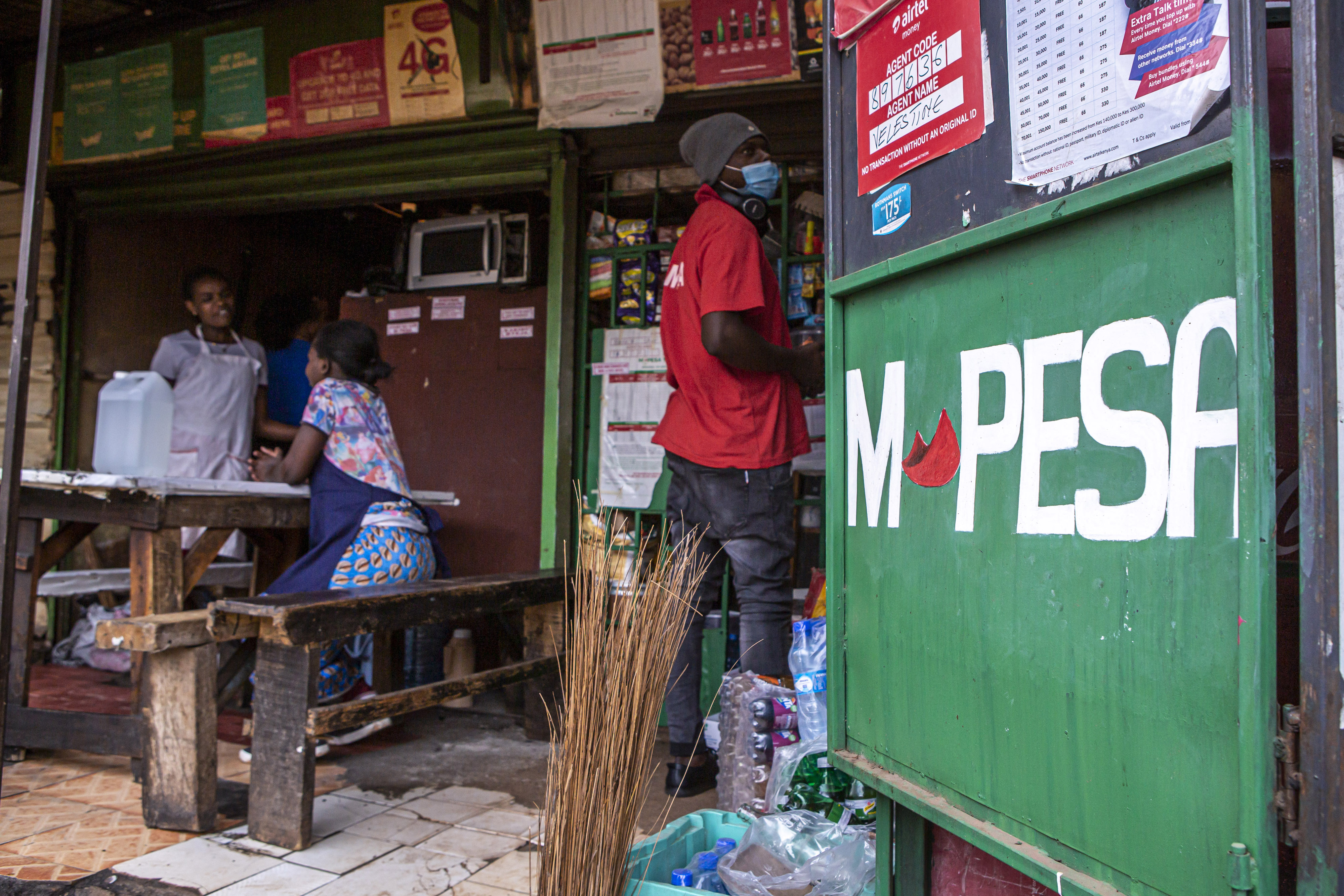 The M-Pesa mobile money service logo appears on a retail kiosk in central Nairobi, in 2021. Africa’s biggest fintech turned 15 this month, and has grown steadily since the onset of the COVID pandemic.
