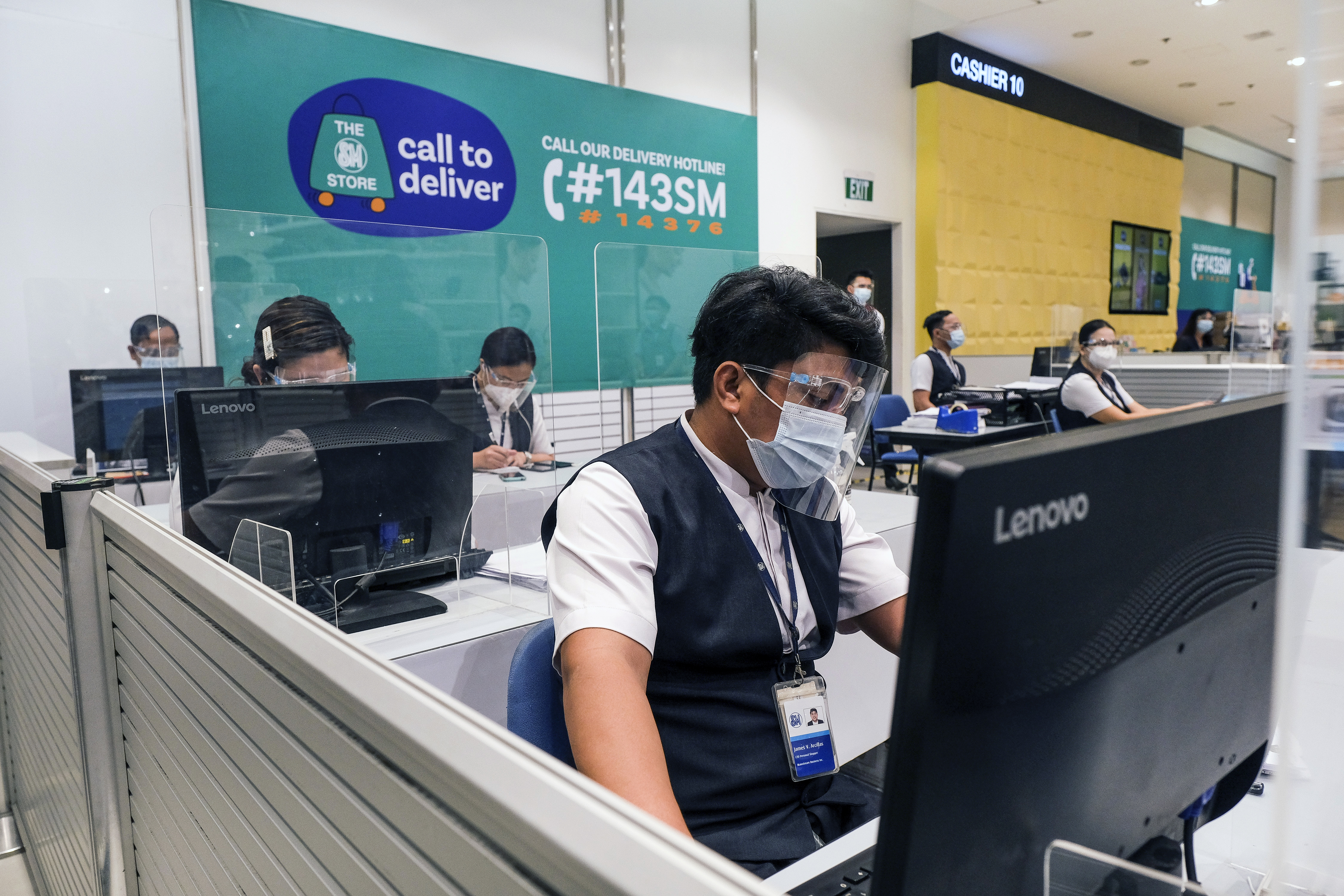 Call-center agents tend to customers ordering over the phone at the SM City Bacoor shopping mall in Bacoor, Cavite province, the Philippines, on June 3, 2021.