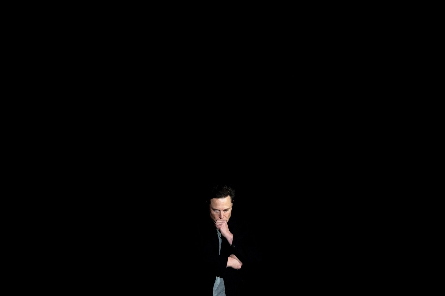 Elon Musk pauses and looks down as he speaks during a press conference at SpaceX's Starbase facility near Boca Chica Village in South Texas on Feb. 10, 2022. Musk has been publicly mum on Twitter users' requests that he disable Teslas in Russia.
