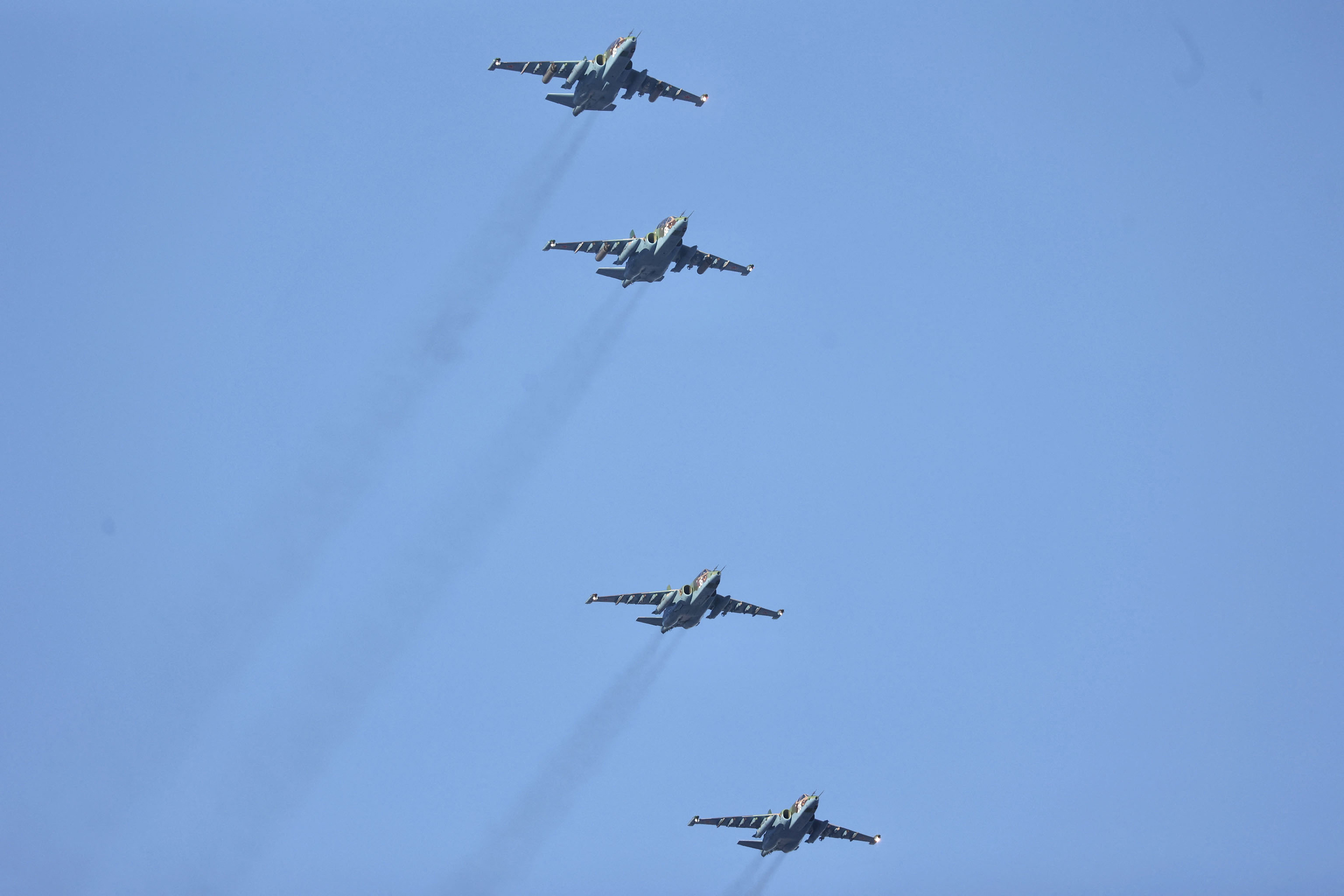 Four fighter jets fly in the sky.