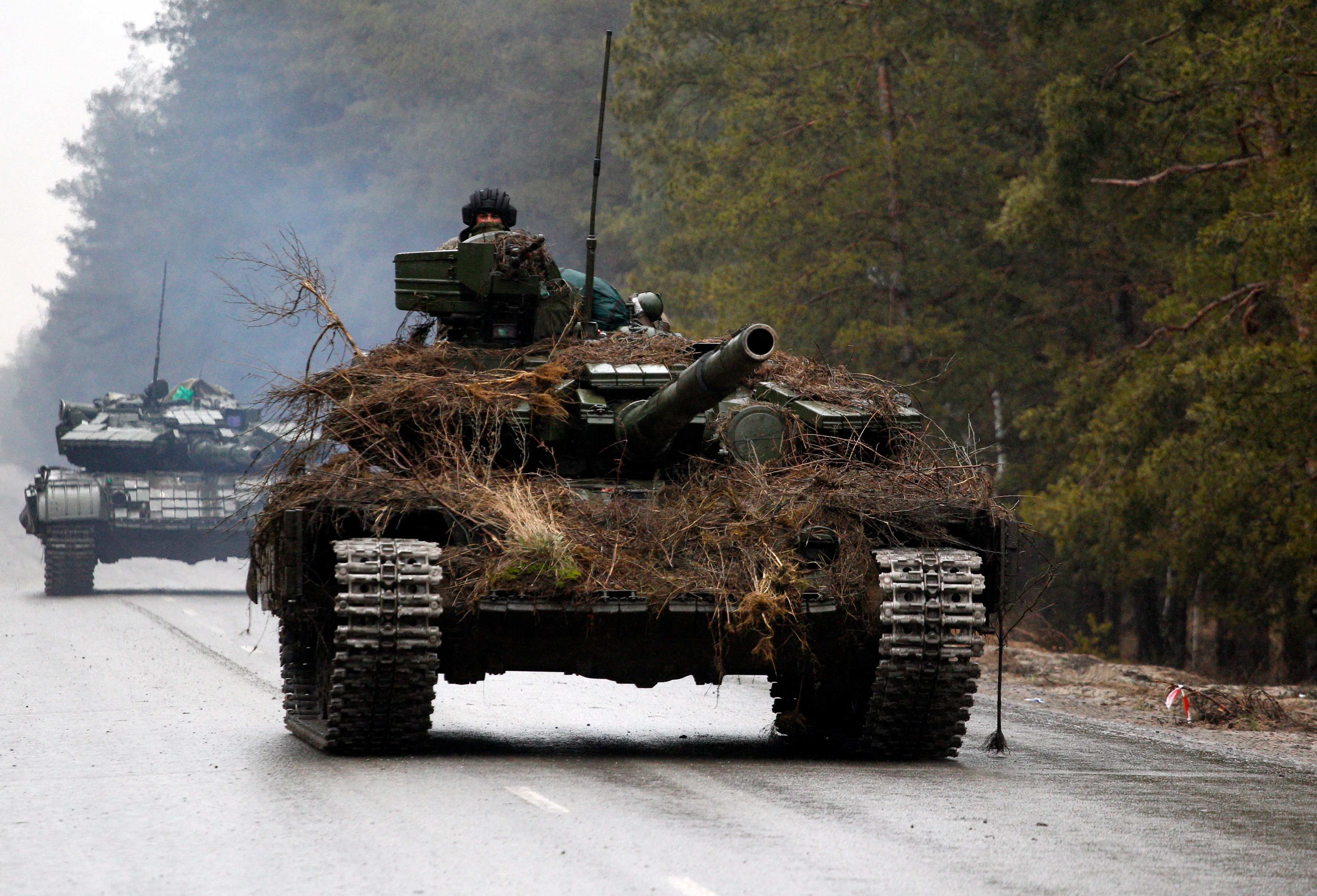 Ukrainian tanks move on a road before an attack in Lugansk region