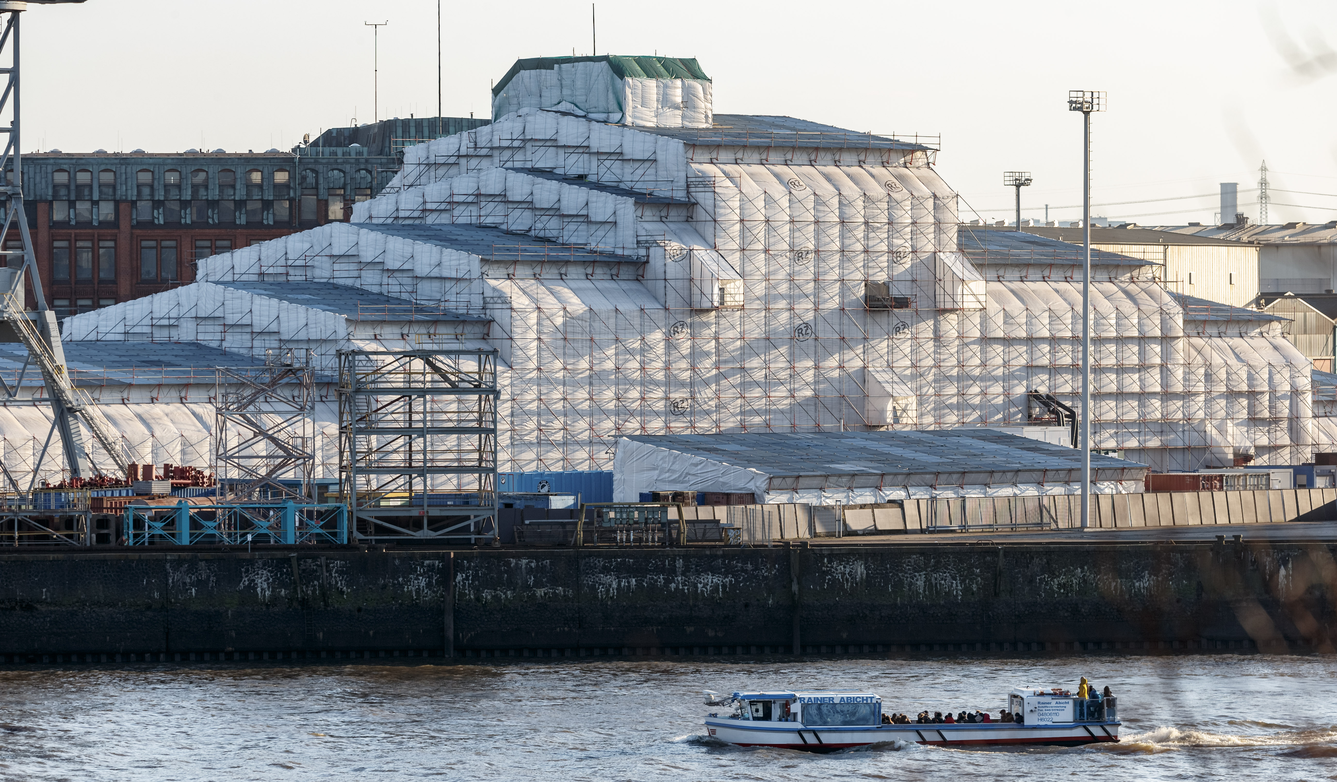 Completely shrouded, the mega-yacht “Dilbar” lies in the Blohm+Voss Dock Elbe 17 in Hamburg. The 156-meter–long ship is said to belong to a Russian oligarch.