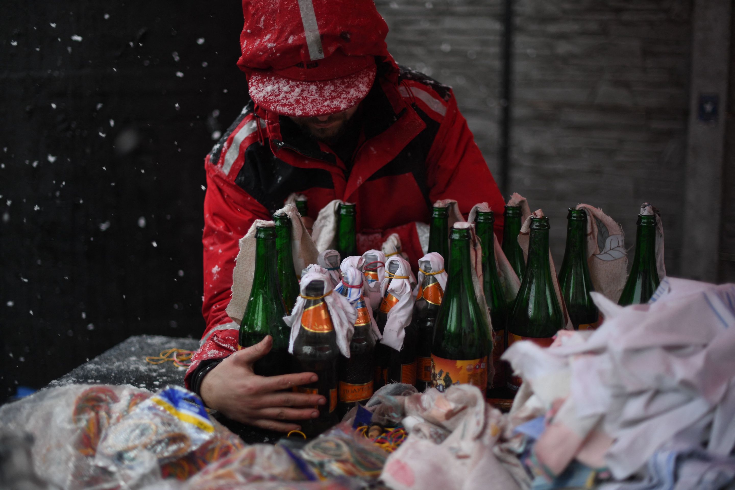 A volunteer demonstrates the preparation of Molotov cocktails at the Pravda - (Truth) brewery in Lviv.