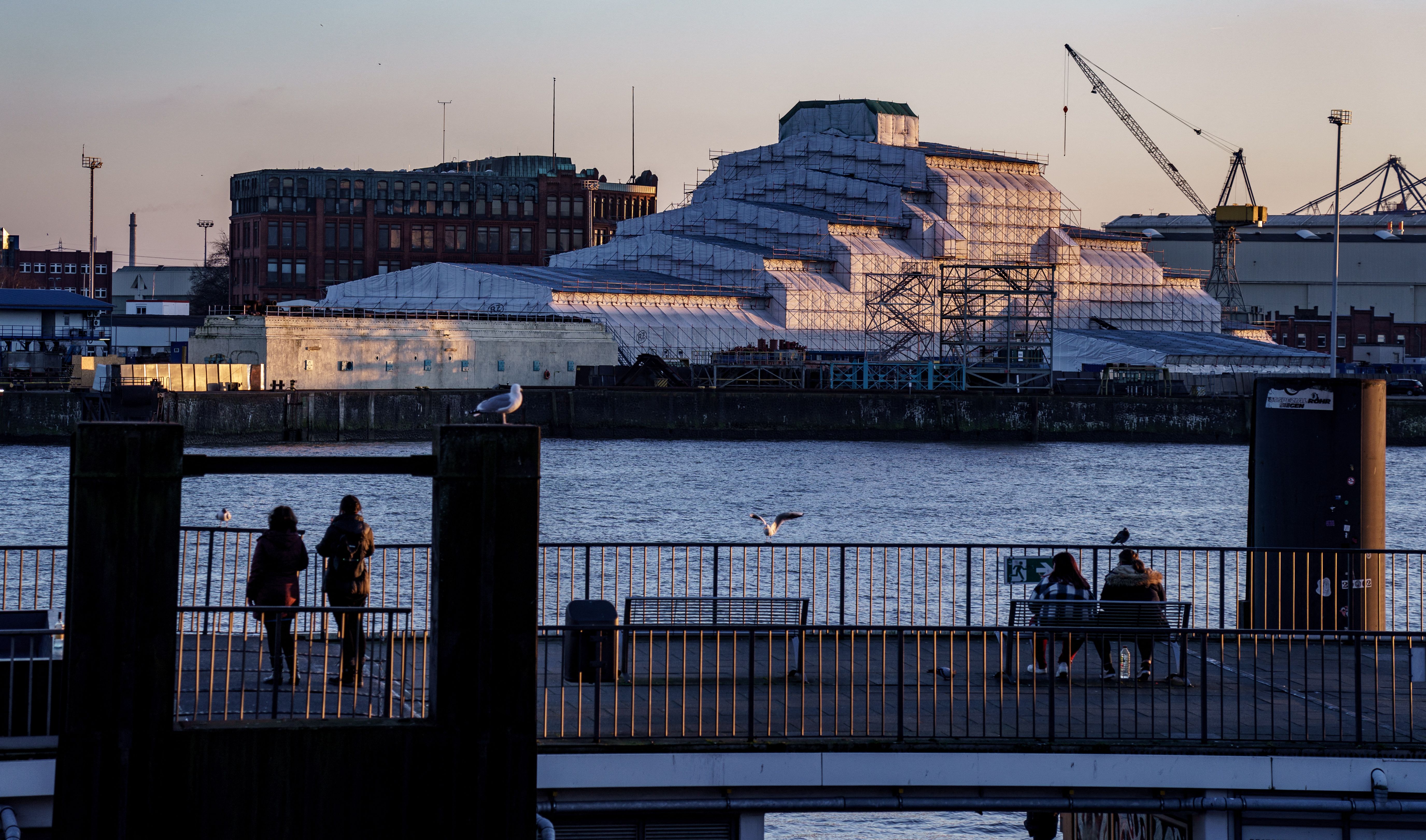 The yacht "Dilbar," covered with plastic sheets and believed to be owned by a Russian oligarch, is docked in a shipyard of Blohm & Voss in the harbour of Hamburg, on the evening of March 3, 2022.