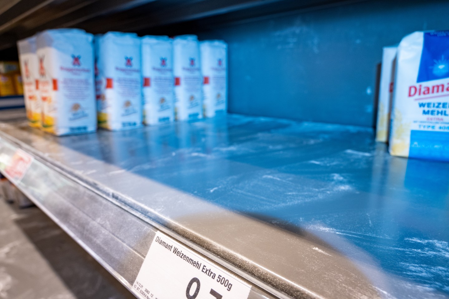 An empty shelf of flour at a grocery store in Germany.