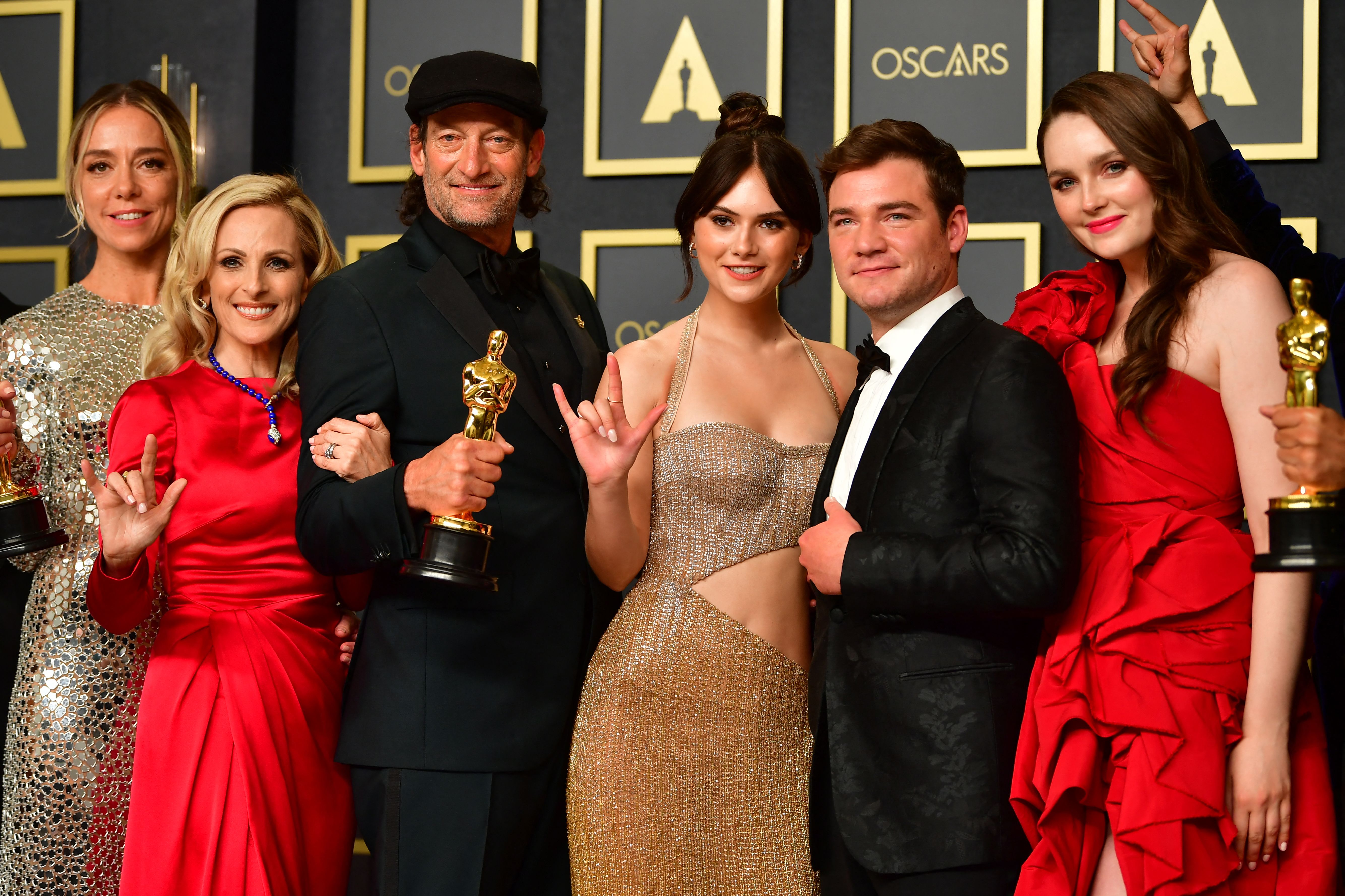 The cast of CODA hold their award for Best Picture.