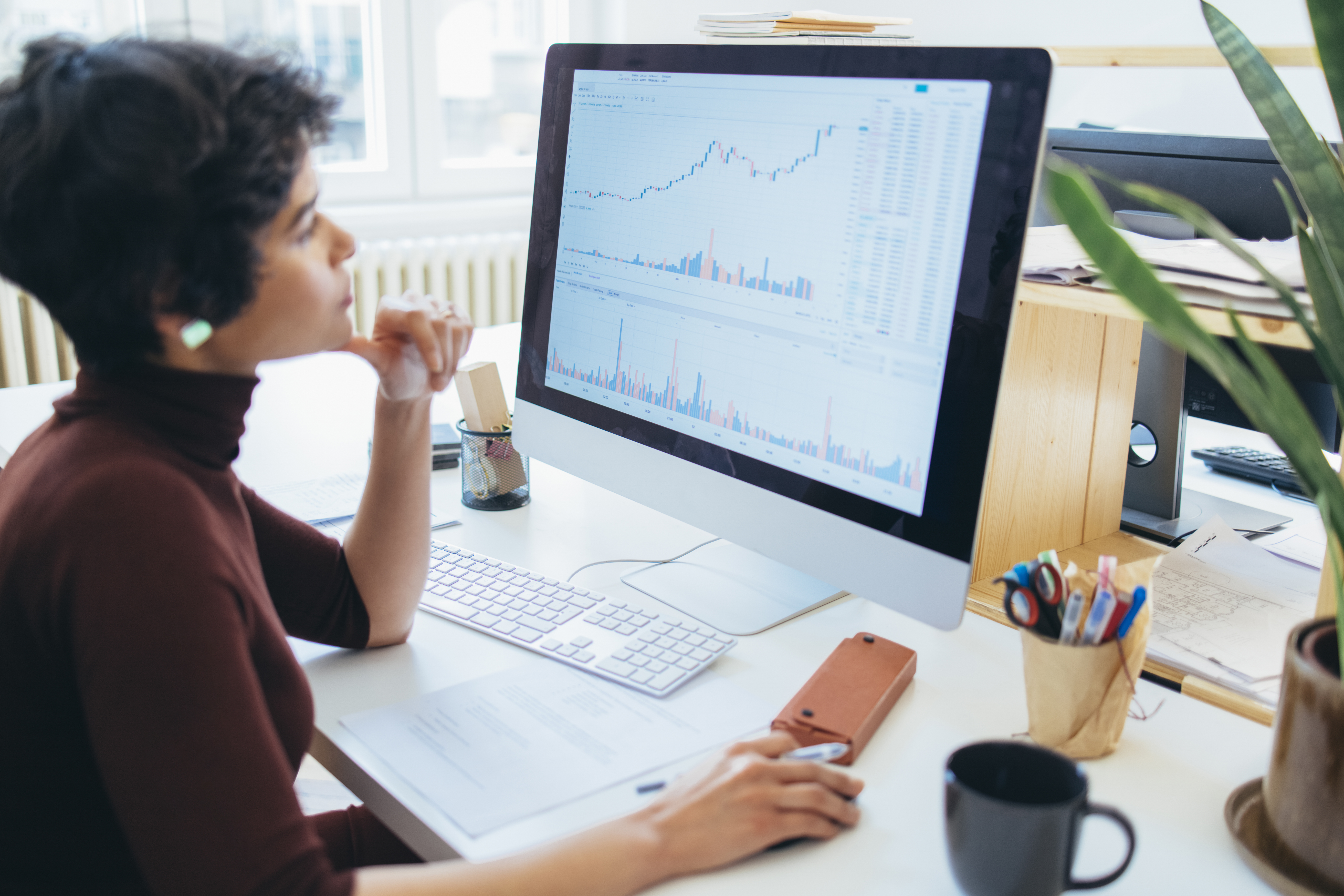 Young female examining the changes in the stock market at her office