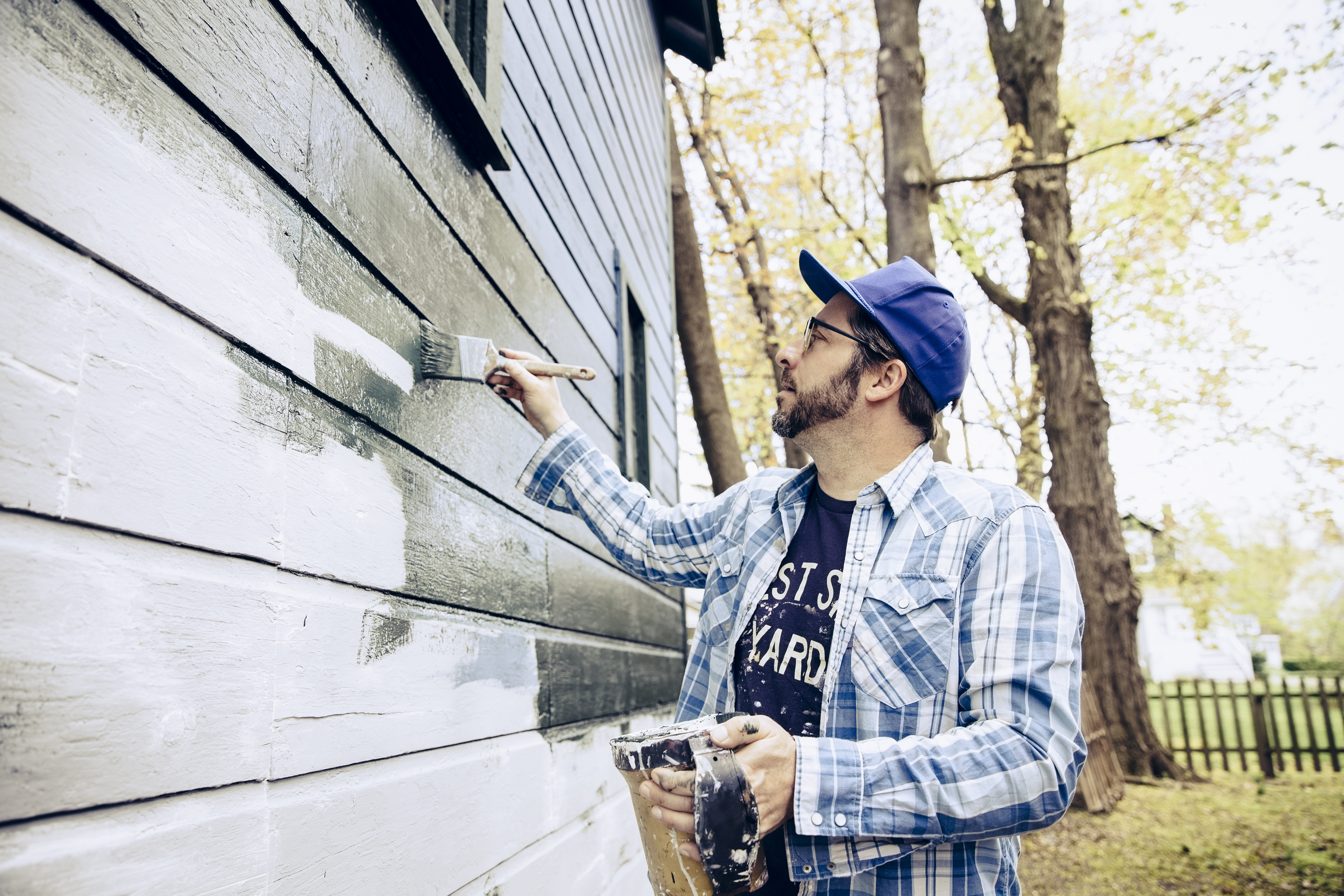 A man painting a home
