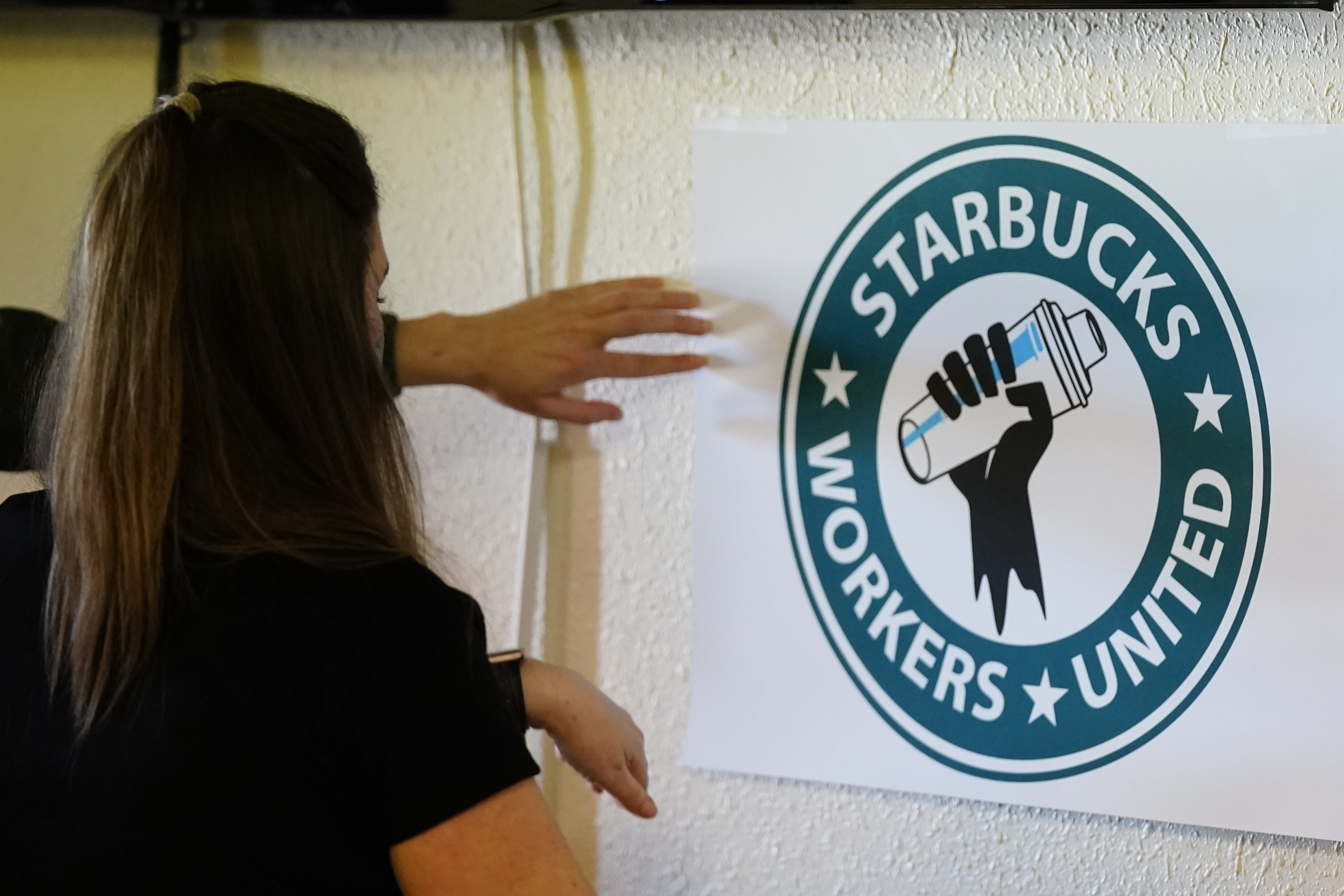 Michelle Eisen, a barista at the Buffalo, N.Y., Elmwood Starbucks location, helps out the local Starbucks Workers United, employees of a local Starbucks, as they gather at a local union hall to cast votes to unionize or not, on Feb. 16, in Mesa, Ariz.