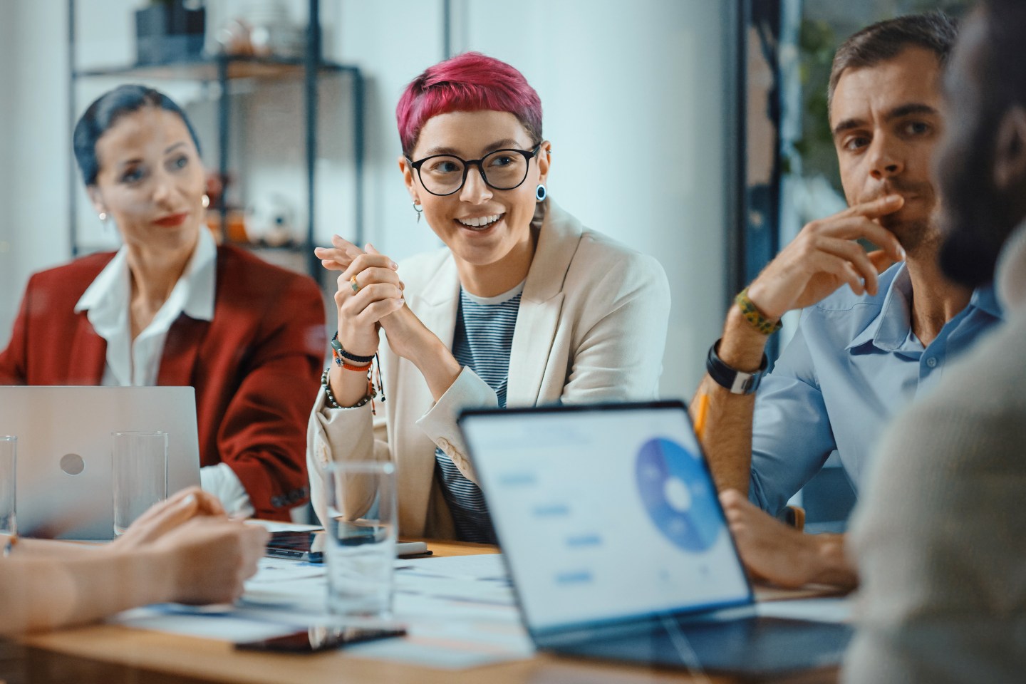 Gen Z woman in a meeting with older employees.