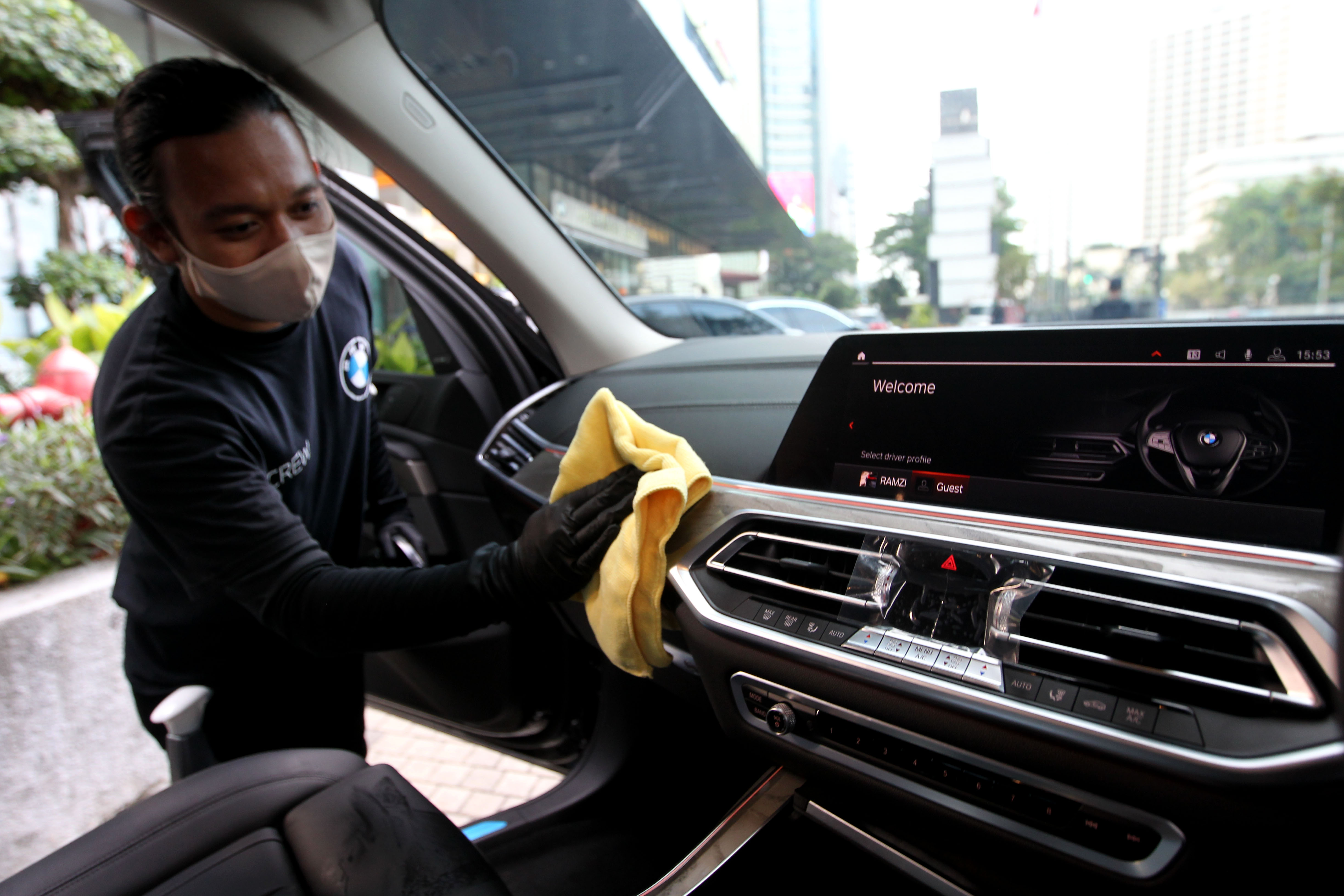 A worker is pictured at a BMW Thamrin dealership in Jakarta on Oct. 24, 2020. BMW Indonesia held a sales program during the Large-Scale Social Restrictions (PSBB) period of the transition to the COVID-19 pandemic in eight BMW Group Indonesia official showrooms by implementing health protocols and filling in the visitors list by scanning the barcode.