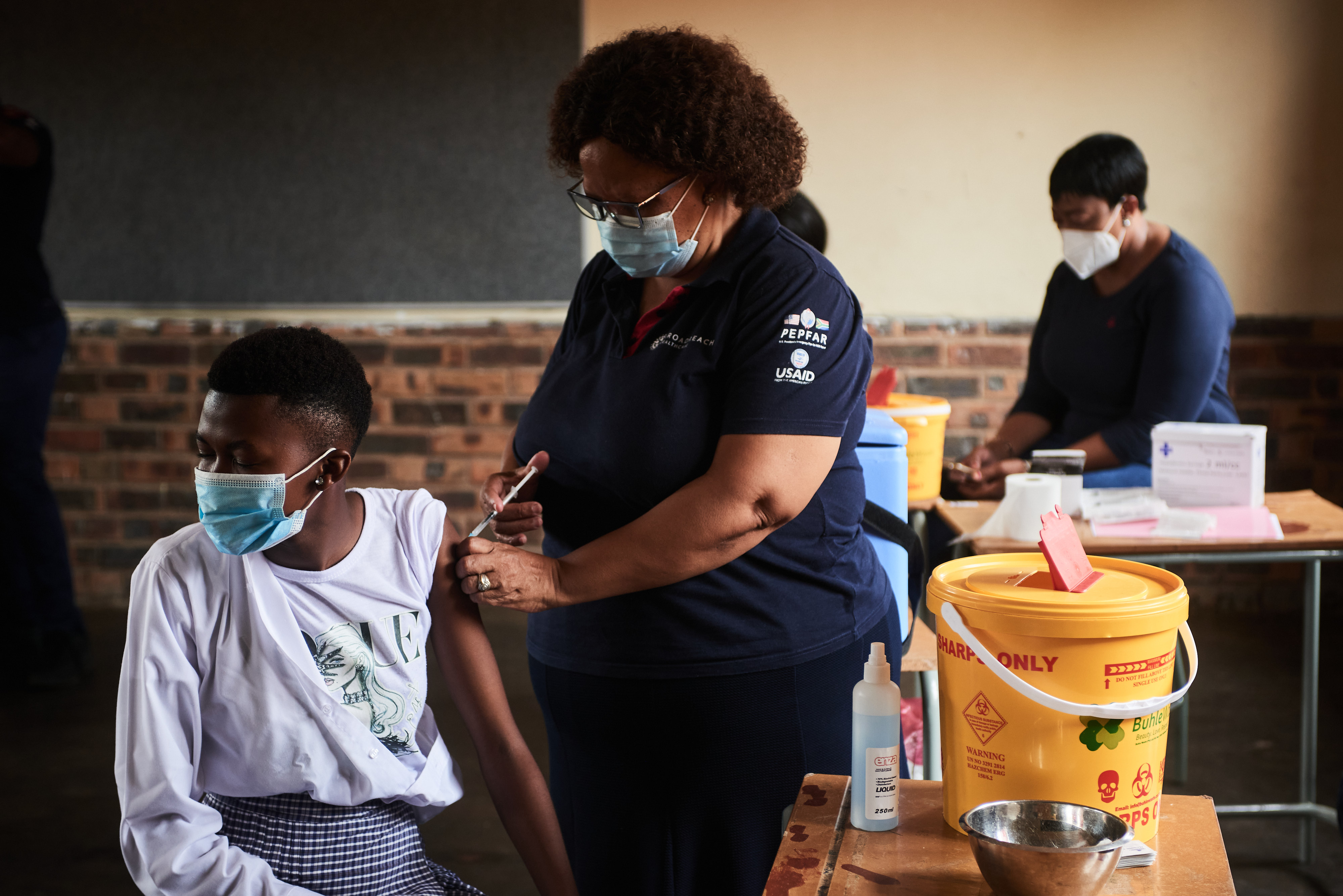 A health worker administers a COVID-19 vaccine to a student during a rural vaccination drive by Broadreach NGO at Duduzile Secondary School in Mpumalanga, South Africa, on March 9, 2022.