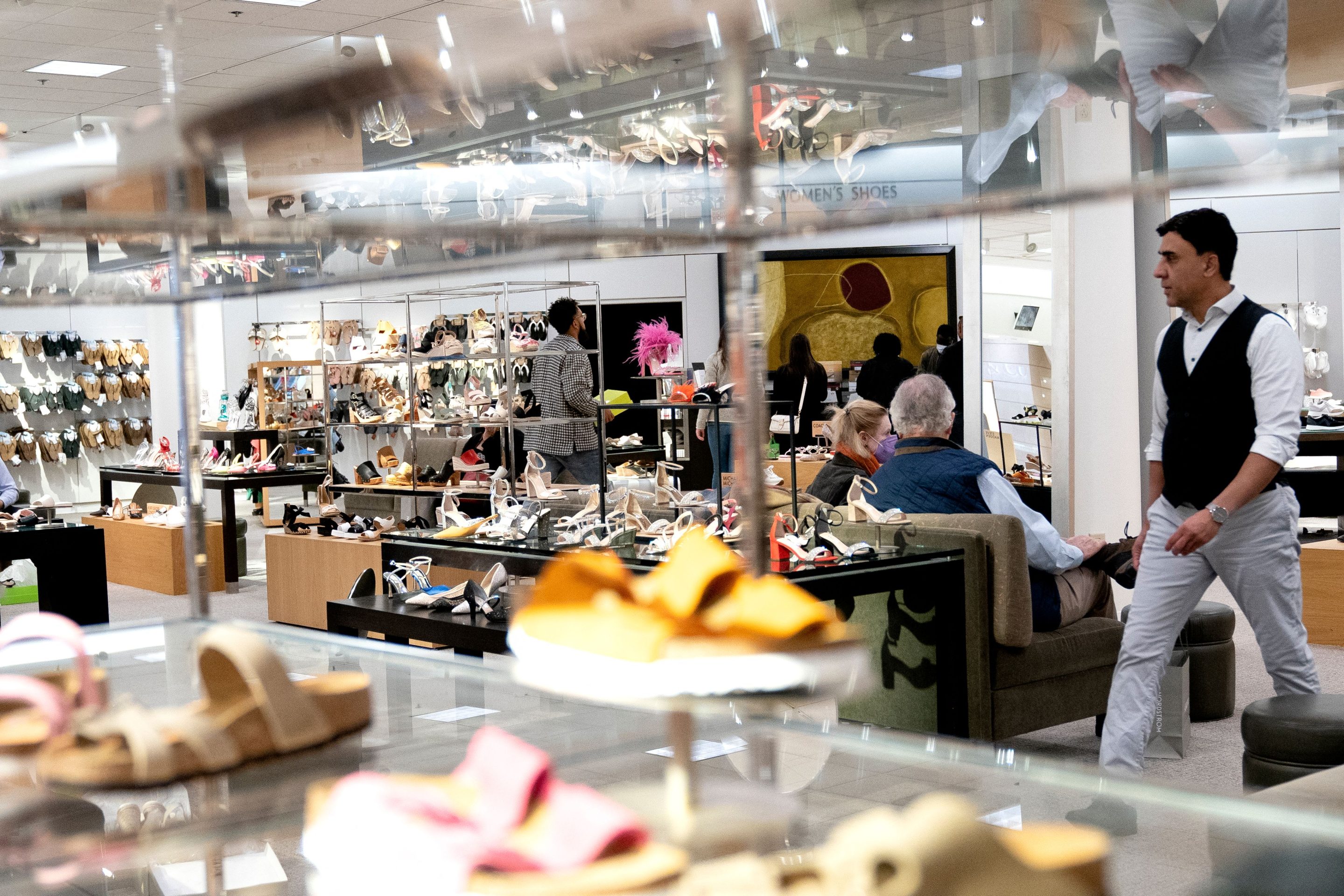 Shoppers walk through a store at Tysons Corner Mall in Tysons, Virginia, on April 2, 2022. Adjusted for inflation, consumer spending rose by 0.2.% in March.
