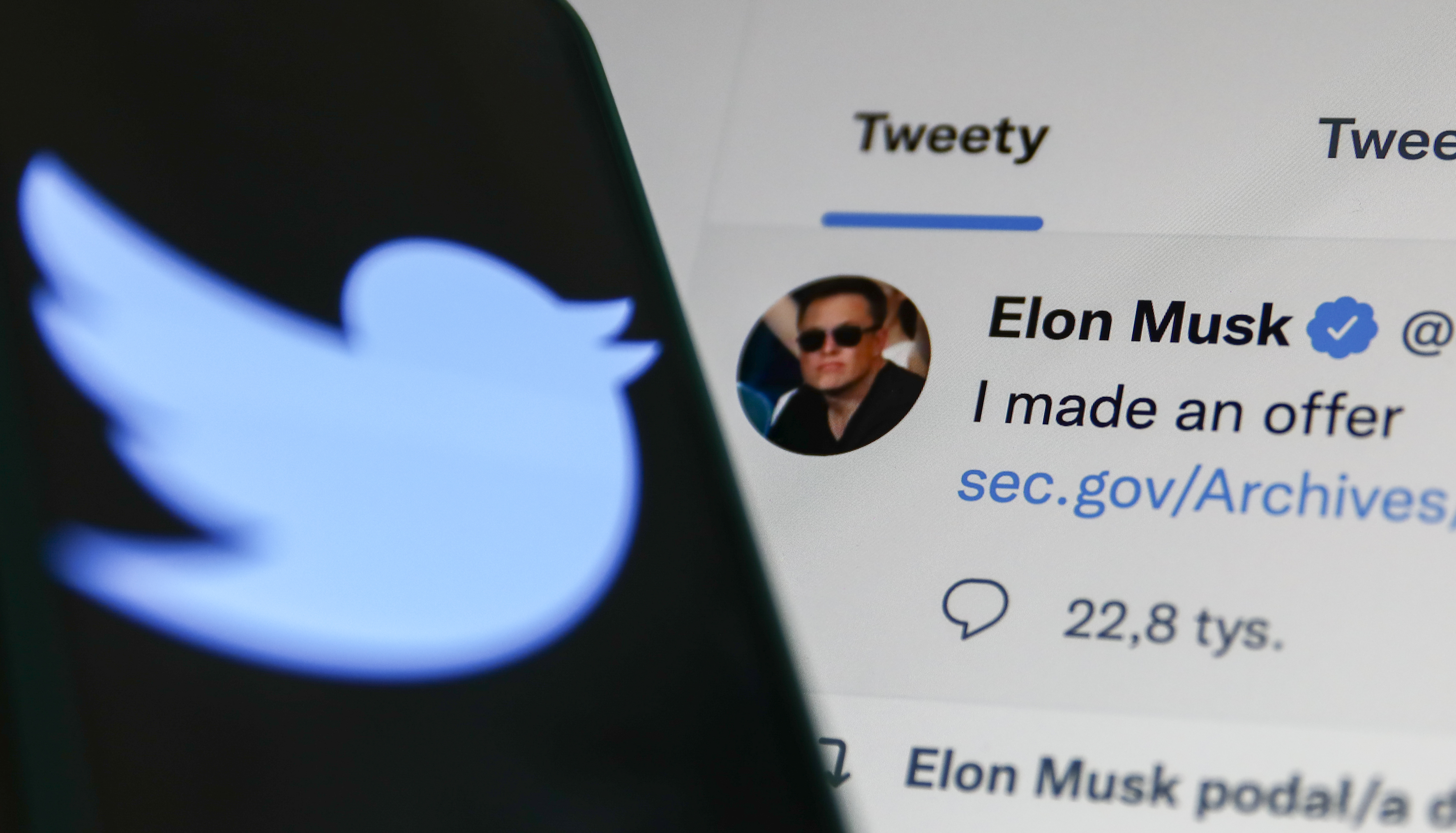 Elon Musk's Tweet displayed on a screen and Twitter logo displayed on a phone screen are seen in this illustration photo taken in Krakow, Poland on April 14.