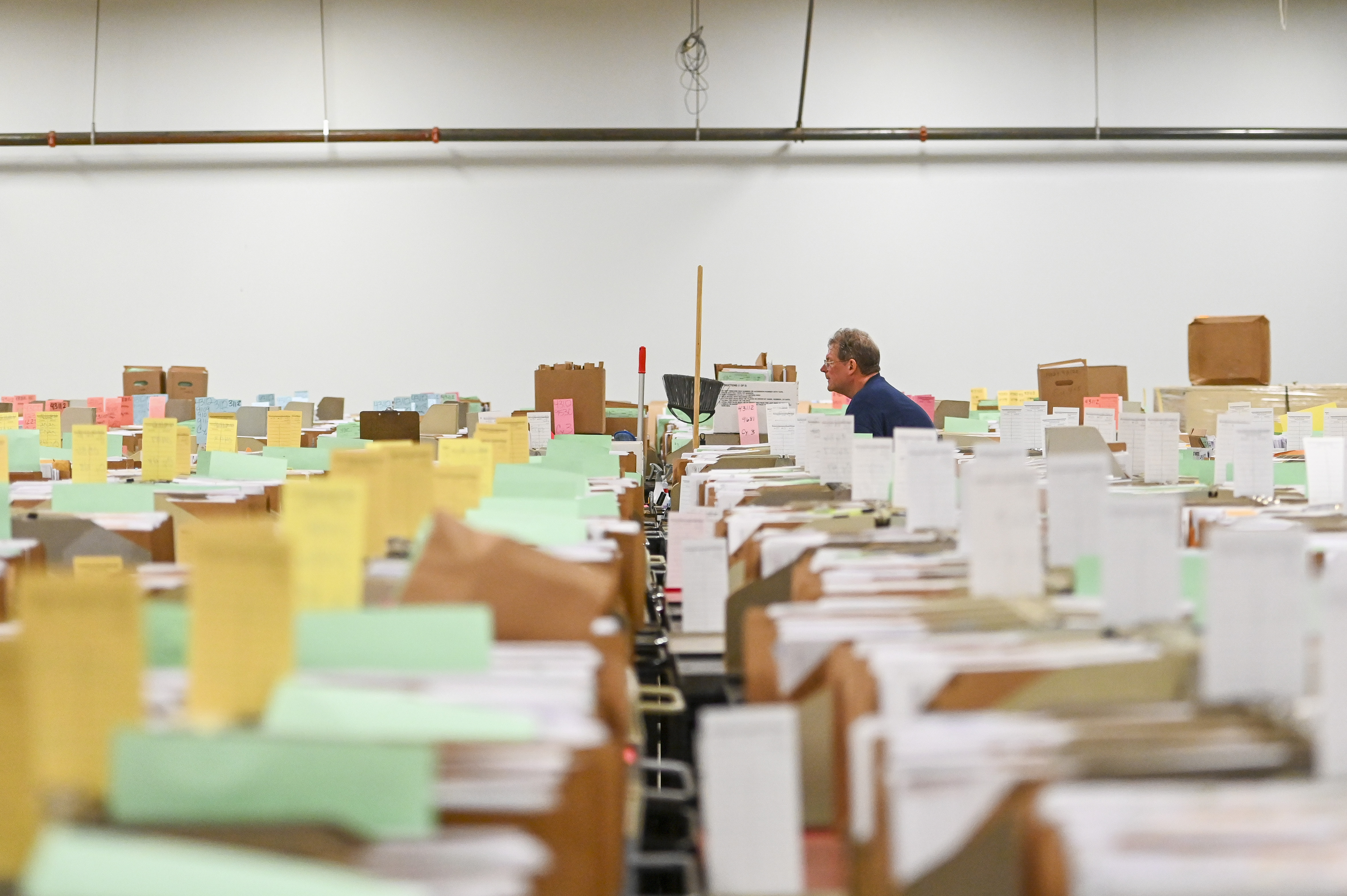 A custodian walks through tax documents in the staging warehouse at an Internal Revenue Service facility on March 31, 2022 in Ogden, Utah.