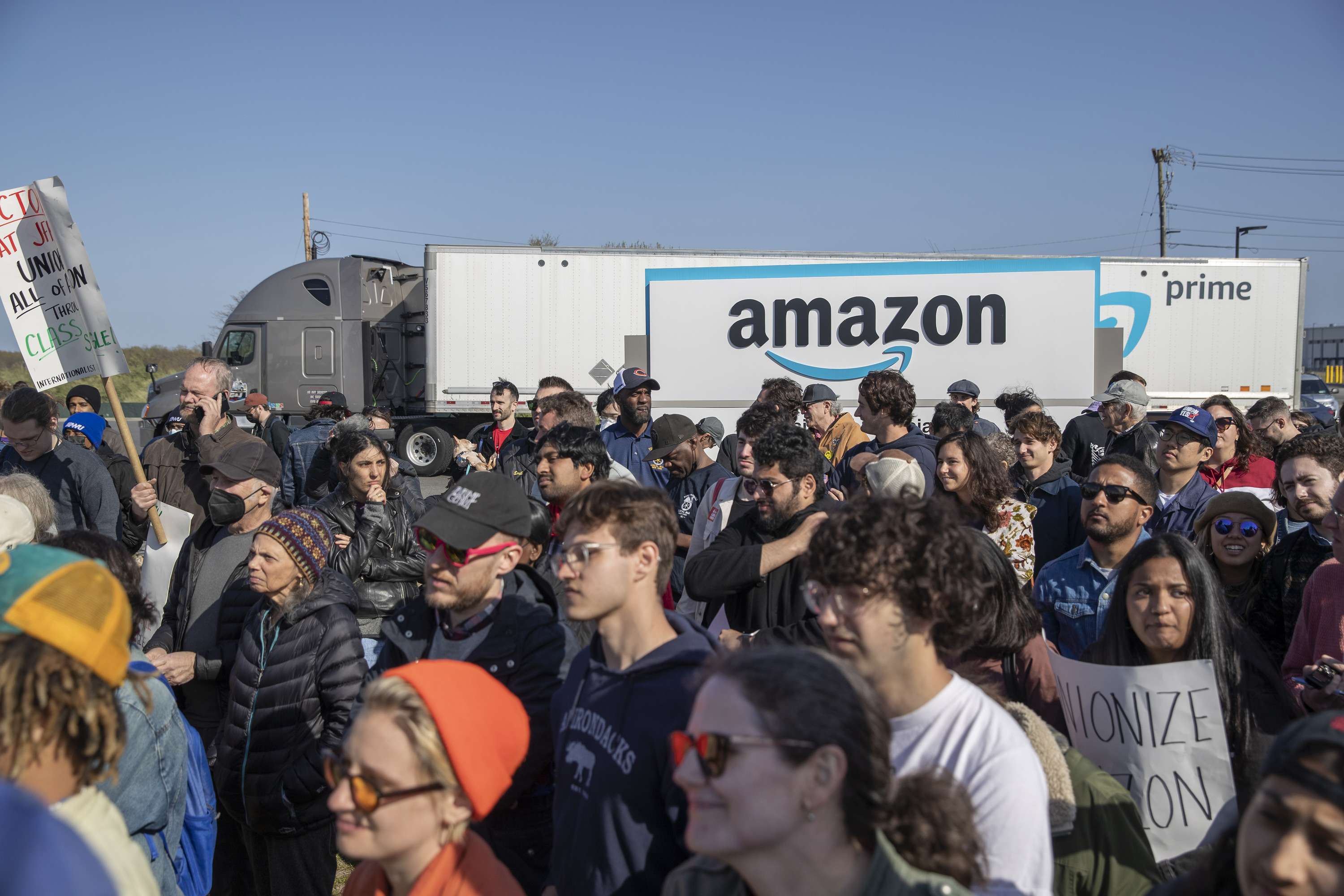 An Amazon truck drives past an Amazon Labor Union (ALU) rally in the Staten Island borough of New York, on April 24, 2022.