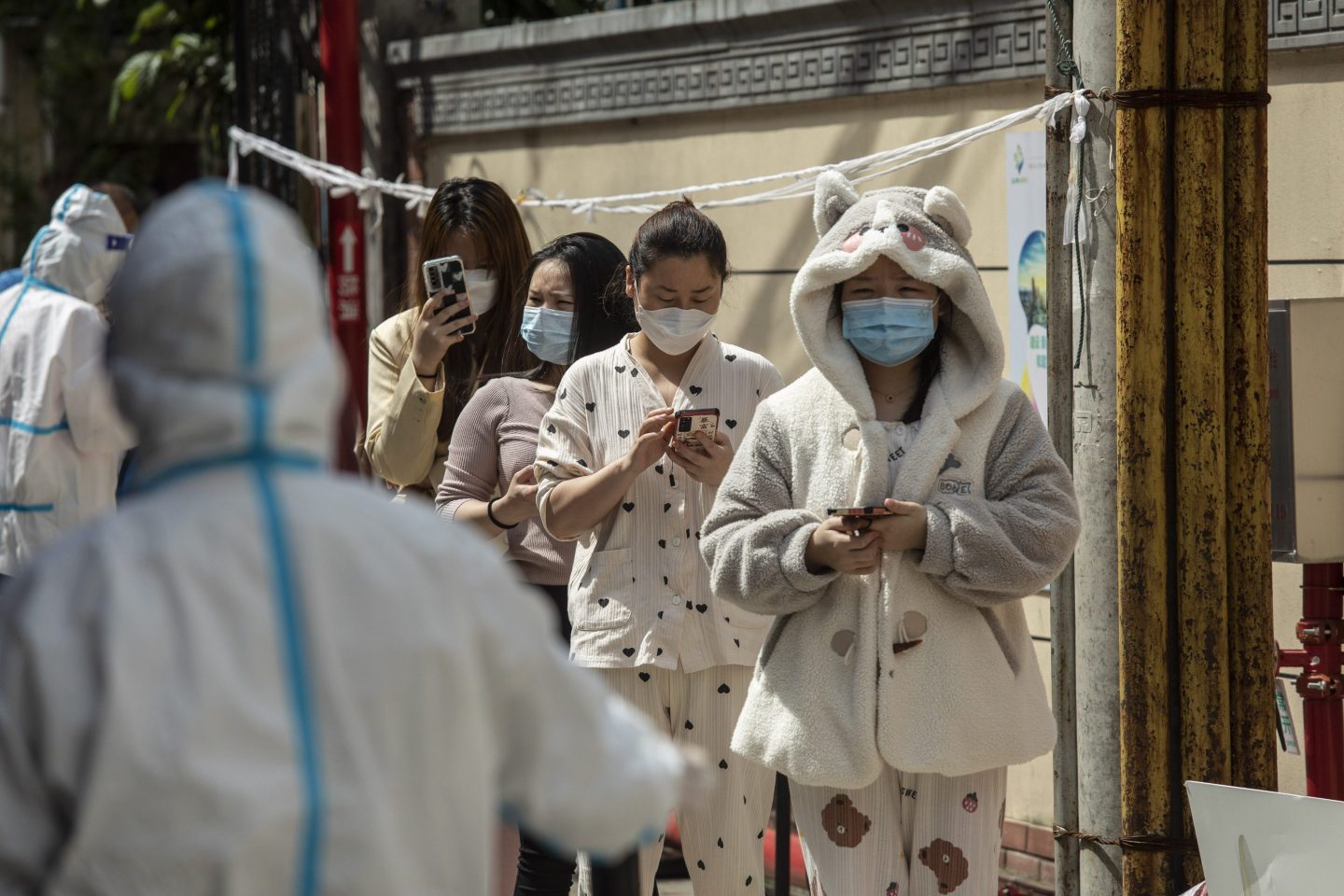 Shanghai residents in pajamas line up for COVID tests