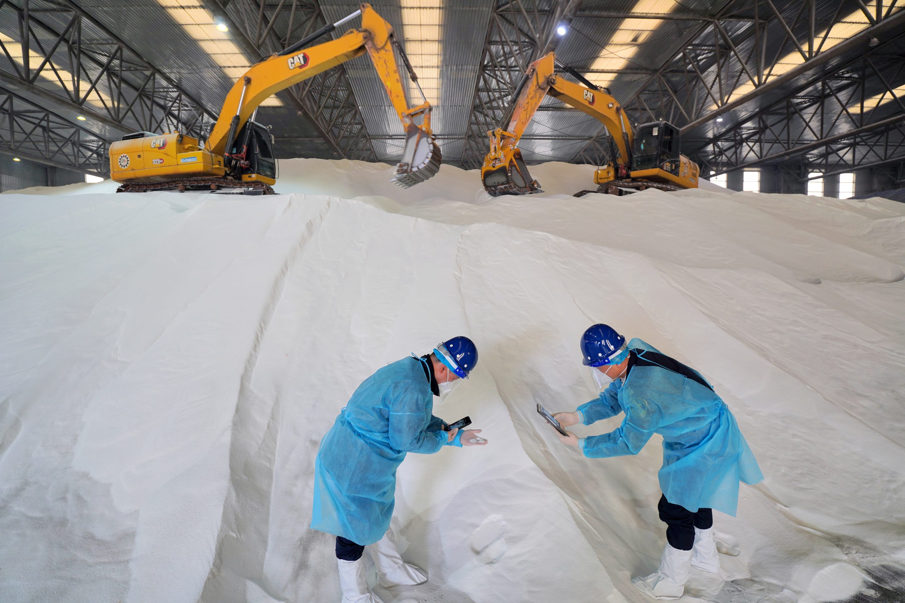 Customs officers inspect imported agricultural fertilizer at Yantai port, in China. Industrial fertilizer is based on an early 20th Century formula, that's highly polluting and energy-intensive.