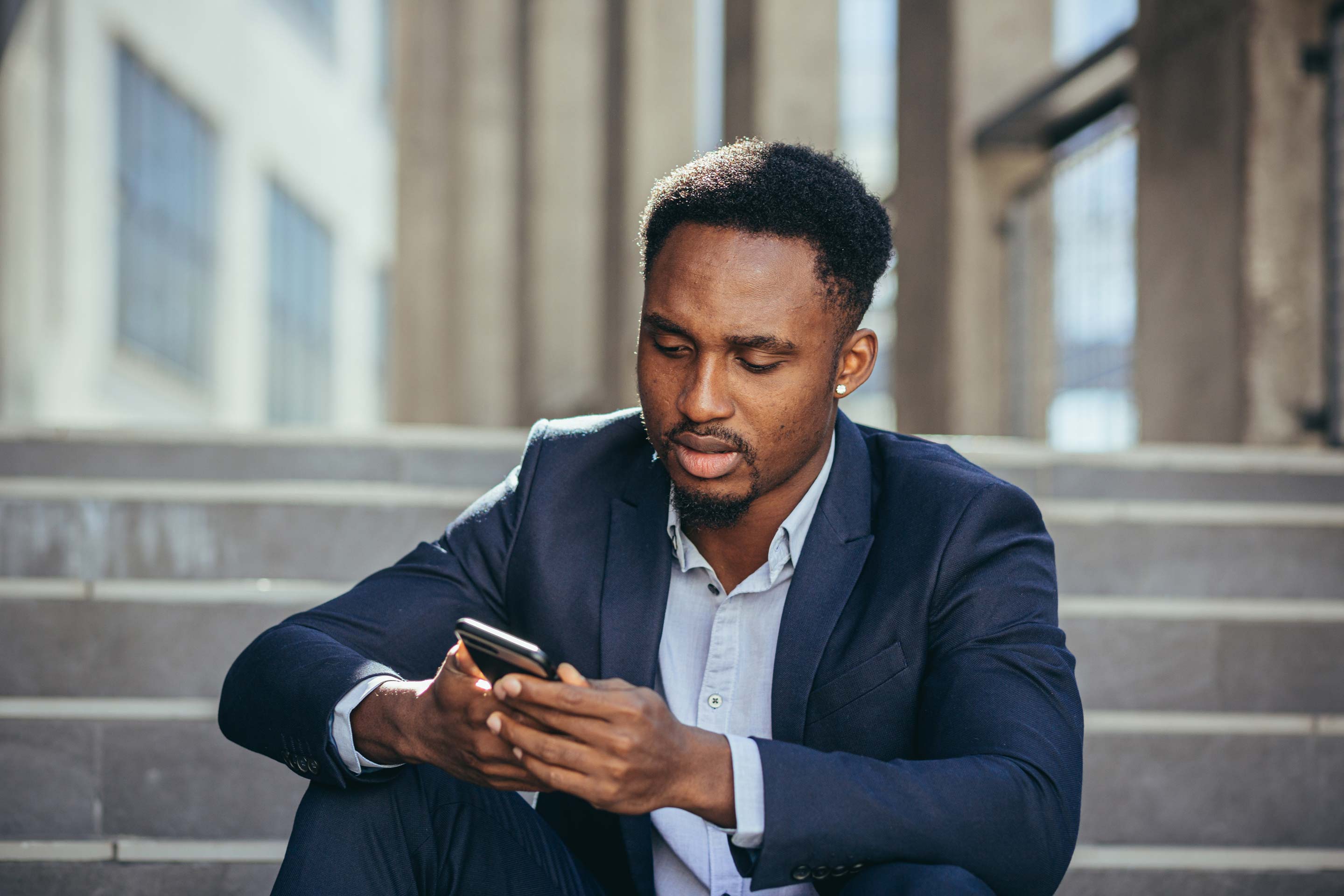 A businessman looking at a cell phone