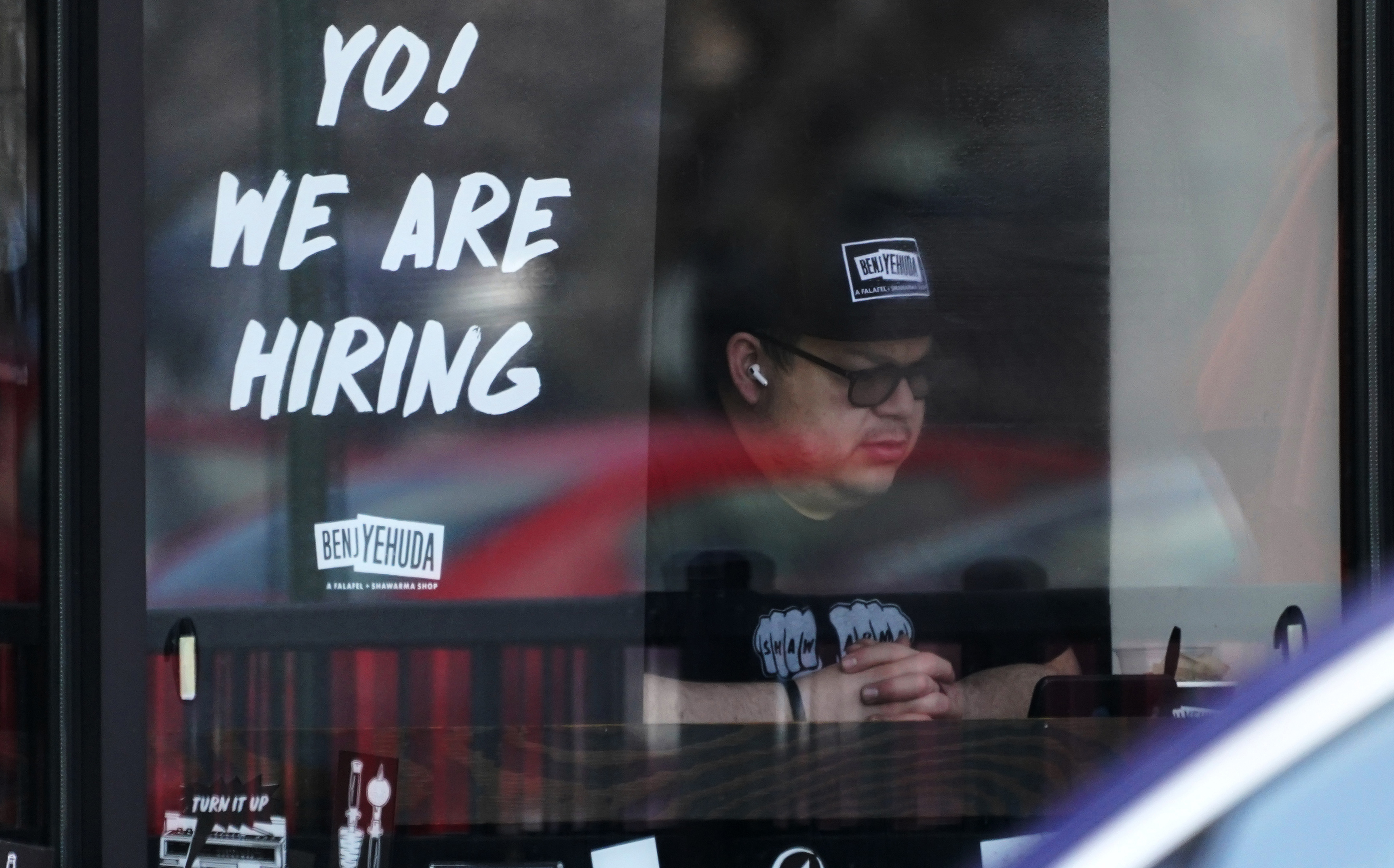 A hiring sign on a business.