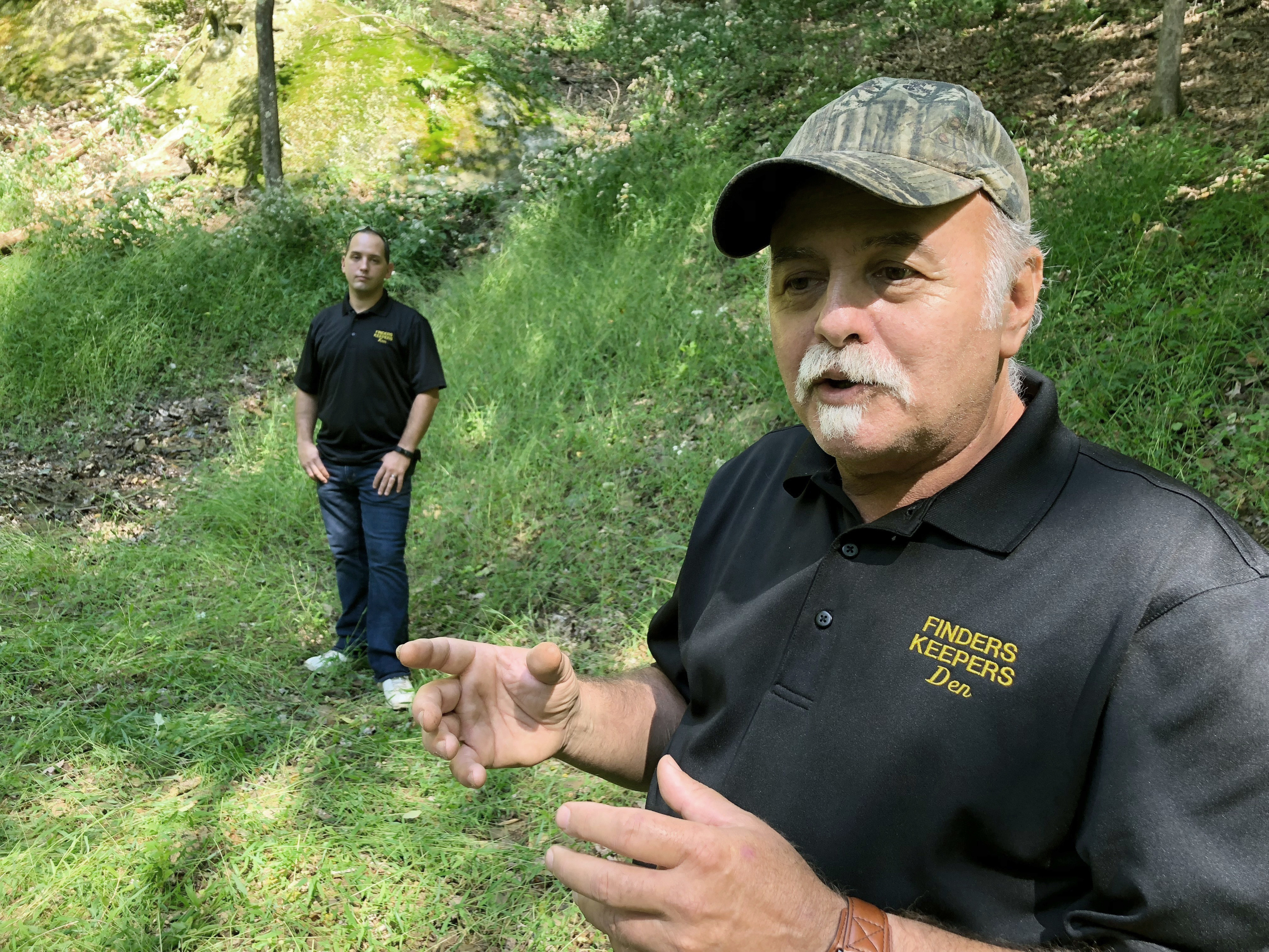 Dennis Parada, right, and his son Kem Parada stand at the site of the FBI's dig for Civil War-era gold in September 2018, in Dents Run, Pennsylvania. A scientific report commissioned by the FBI shortly before agents went digging for buried treasure suggested that a huge quantity of gold was below the surface, according to newly released government documents.