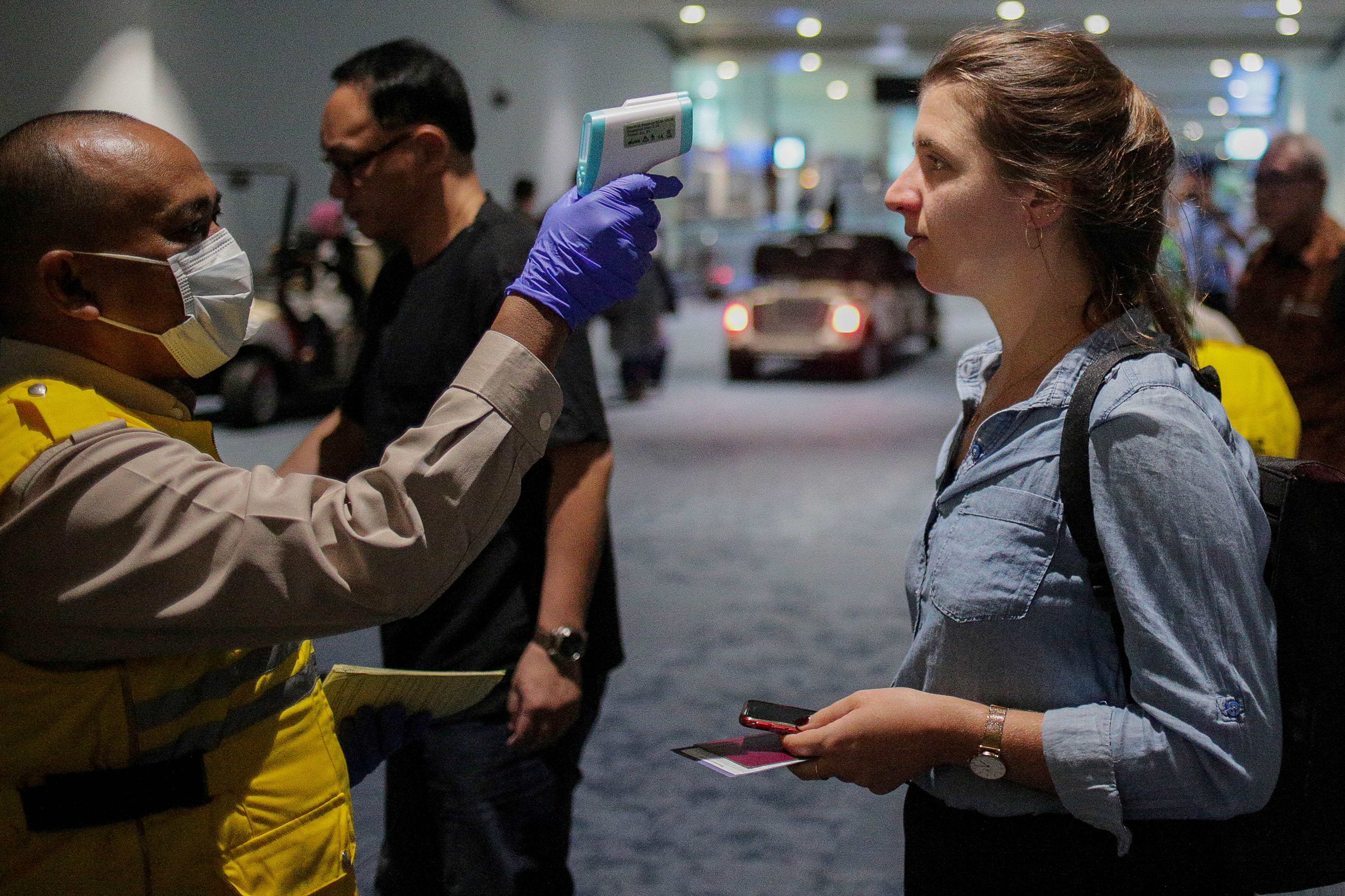 Health officer uses a thermal head to detect a monkeypox virus on arriving passengers at Soekarno-Hatta International Airport in Tangerang near Jakarta, Indonesia, on May 15, 2019.