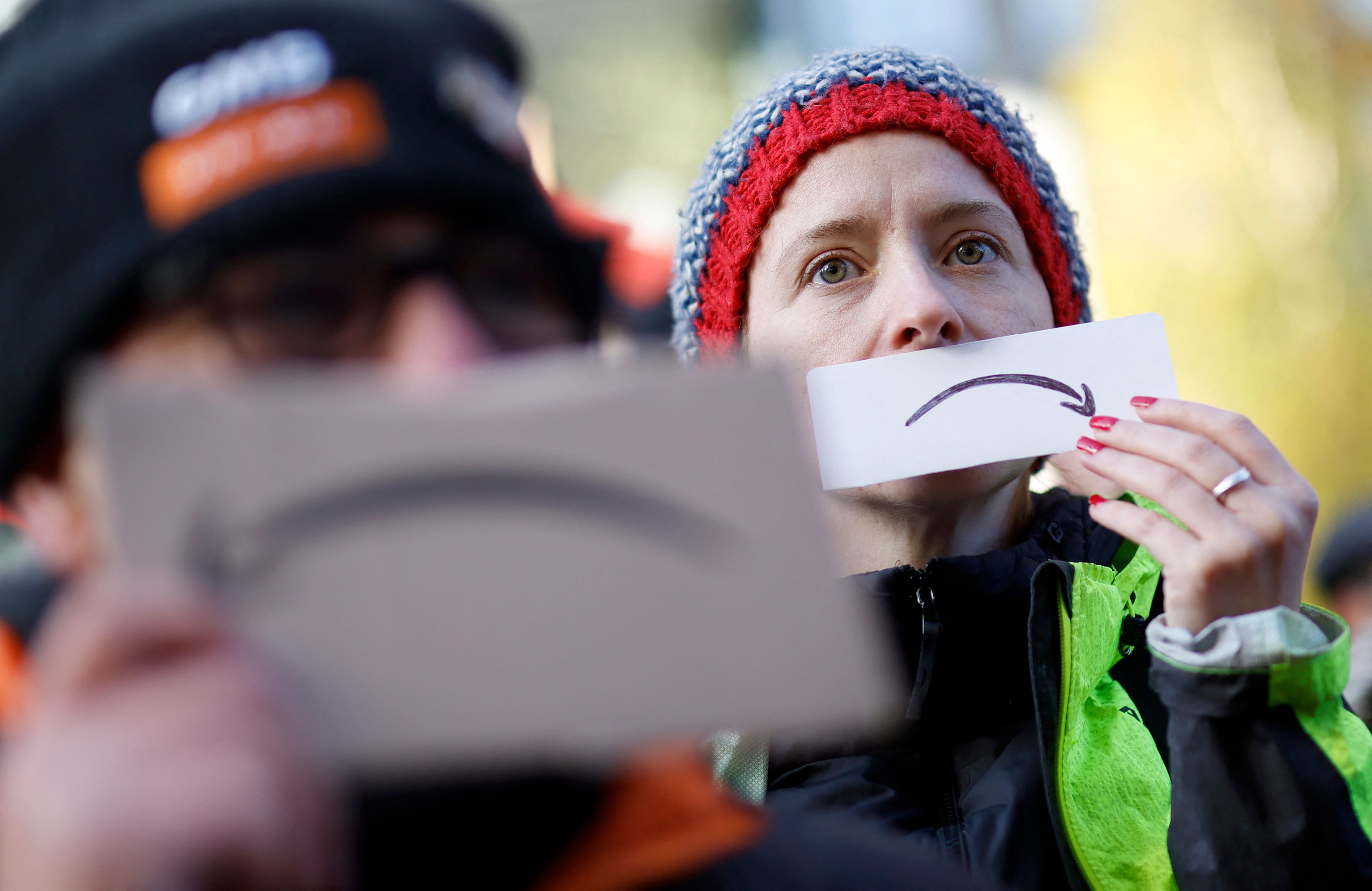 Activists from the Extinction Rebellion (XR) climate change group take part in a protest outside of Amazon's headquarters in central London on Nov. 26, 2021.