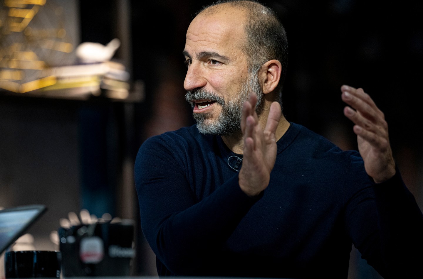 The photograph shows a still from a Bloomberg interview with Dara Khosrowshahi, Uber's CEO.