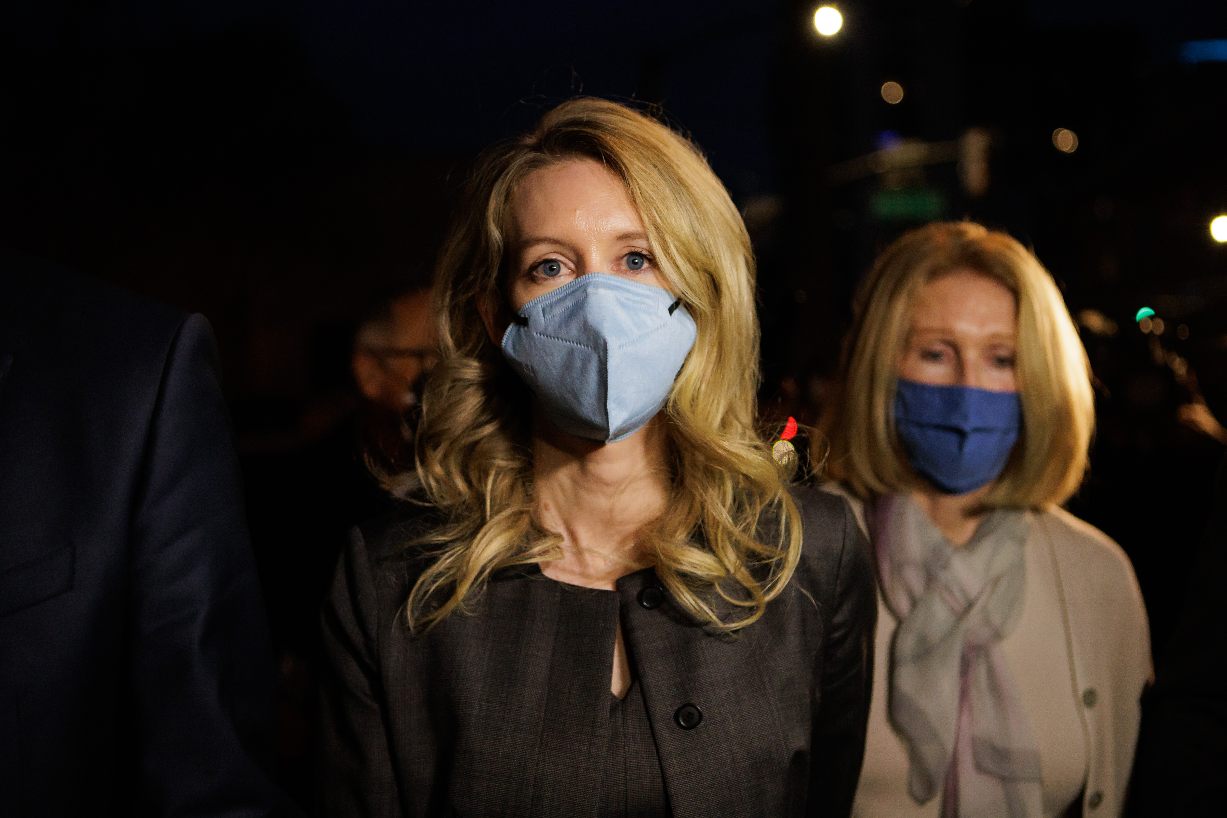 Theranos founder Elizabeth Holmes, center, and her family leave the Robert F. Peckham Federal Building and U.S. Courthouse after the jury found her guilty on four counts in San Jose, Calif., on Monday, Jan. 3. Holmes was found guilty of four counts of defrauding investors, each carrying a maximum penalty of 20 years in prison.
