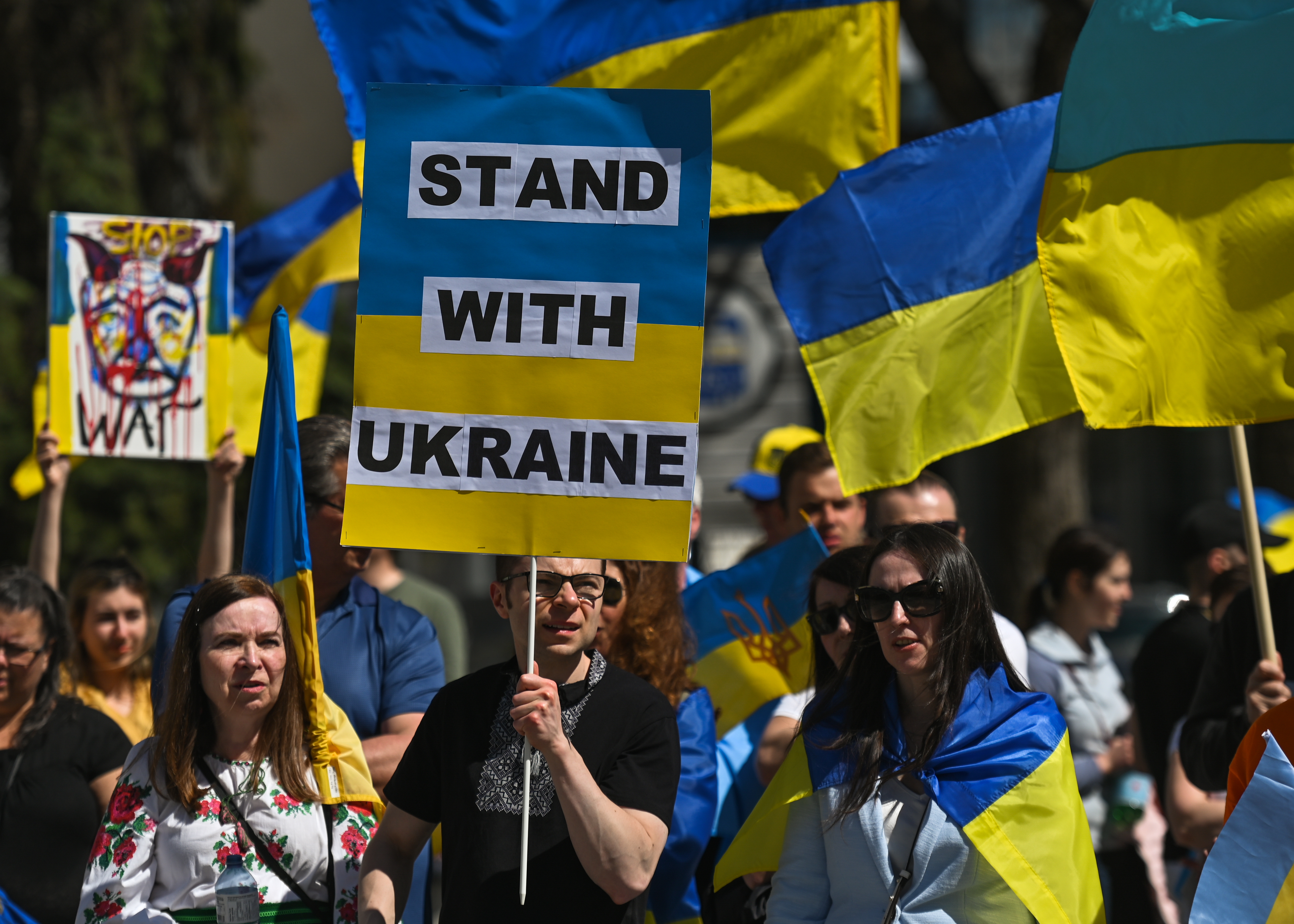 A protester holds a placard with words 'Stand With Ukraine'. Members of the local Ukrainian diaspora, peace activists and supporters took part in 'Alberta Stands with Ukraine!' - a protest organized by the Edmonton Branch of the Ukrainian Canadian Congress in front of Edmonton City Hall.