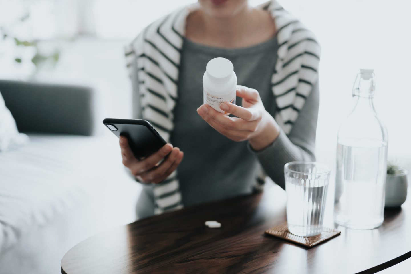 Young woman holds a prescription bottle