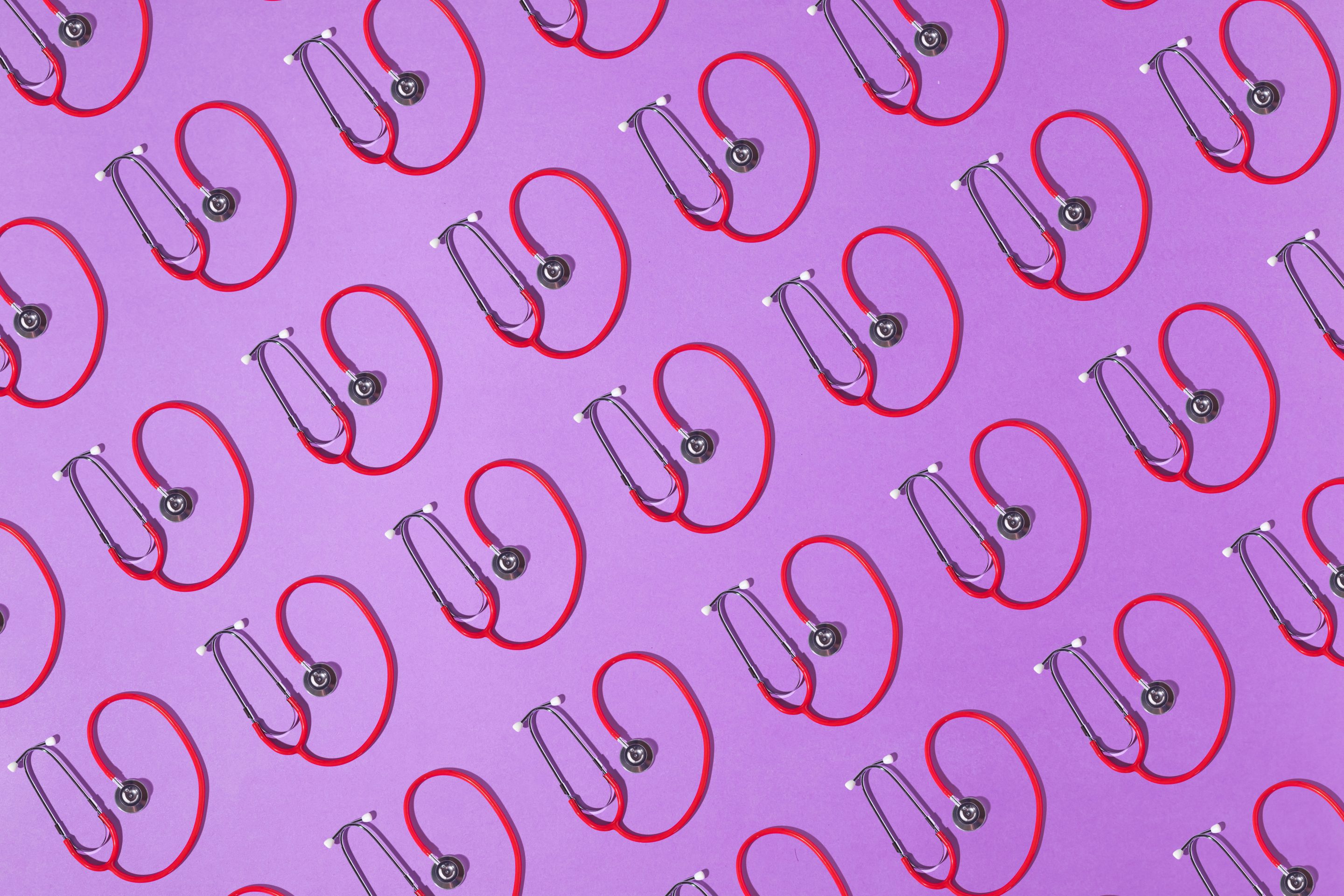 Red and silver stethoscopes pattern on a purple background.