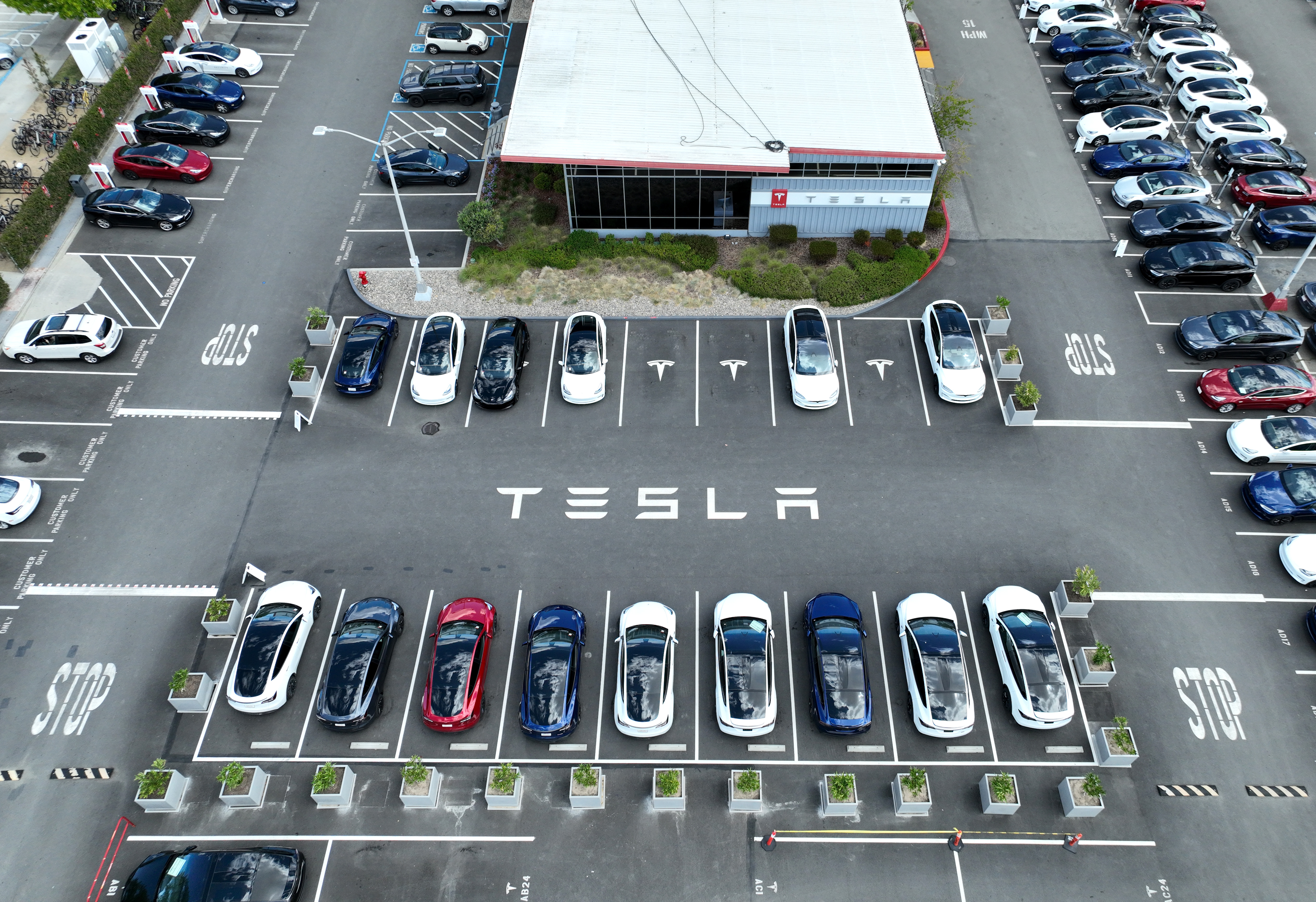 Tesla cars sit parked in a lot at the Tesla factory on April 20, 2022 in Fremont, Calif. 