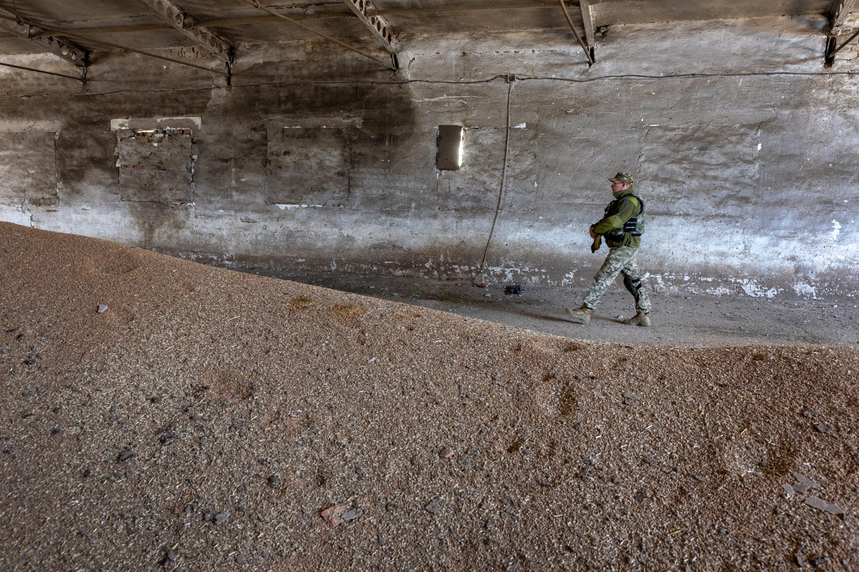 A Ukrainian army officer inspects a grain warehouse earlier shelled by Russian forces on May 06, 2022 near the frontlines of Kherson Oblast in Novovorontsovka, Ukraine. Russia has been accused of targeting food storage sites in frontline areas and generally degrading Ukraine's wheat production, potentially causing a global shortage. The region's provincial capital, Kherson, fell to Russia shortly after the Feb. 24 invasion, as Russia sought to create a land bridge between the Crimean peninsula and the eastern Donbas region.