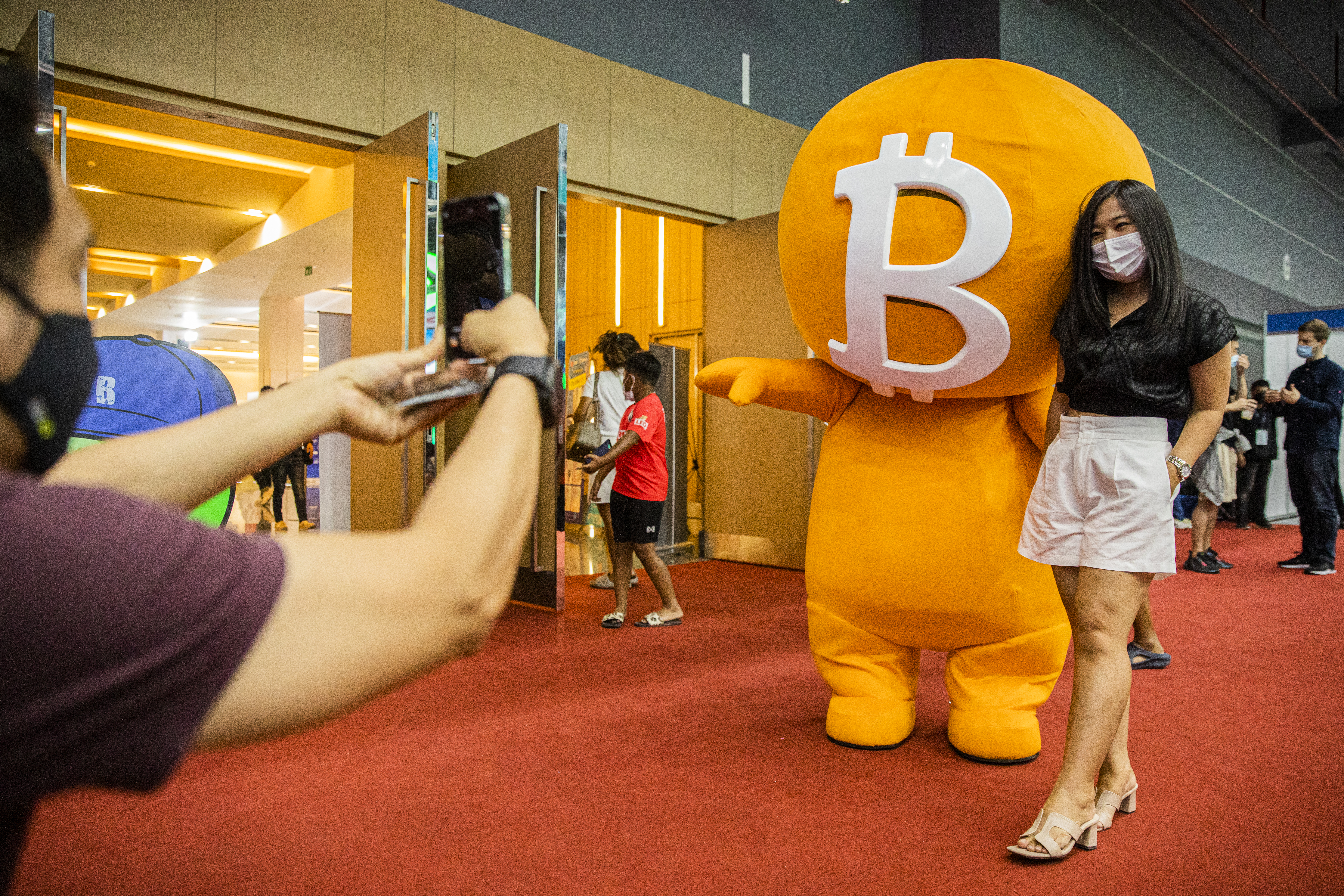 A woman poses with a Bitcoin mascot during the Thailand Crypto Expo 2022 on May 14 in Bangkok, Thailand. Cryptocurrency Enthusiasts attend Thailand Crypto Expo 2022, the largest cryptocurrency exposition in Southeast Asia, at the Bangkok International Trade and Exhibition Center. Visitors learn about blockchain projects, exchanges, mining, NFT production, and gamefi technology. The exposition comes during a global market crash.