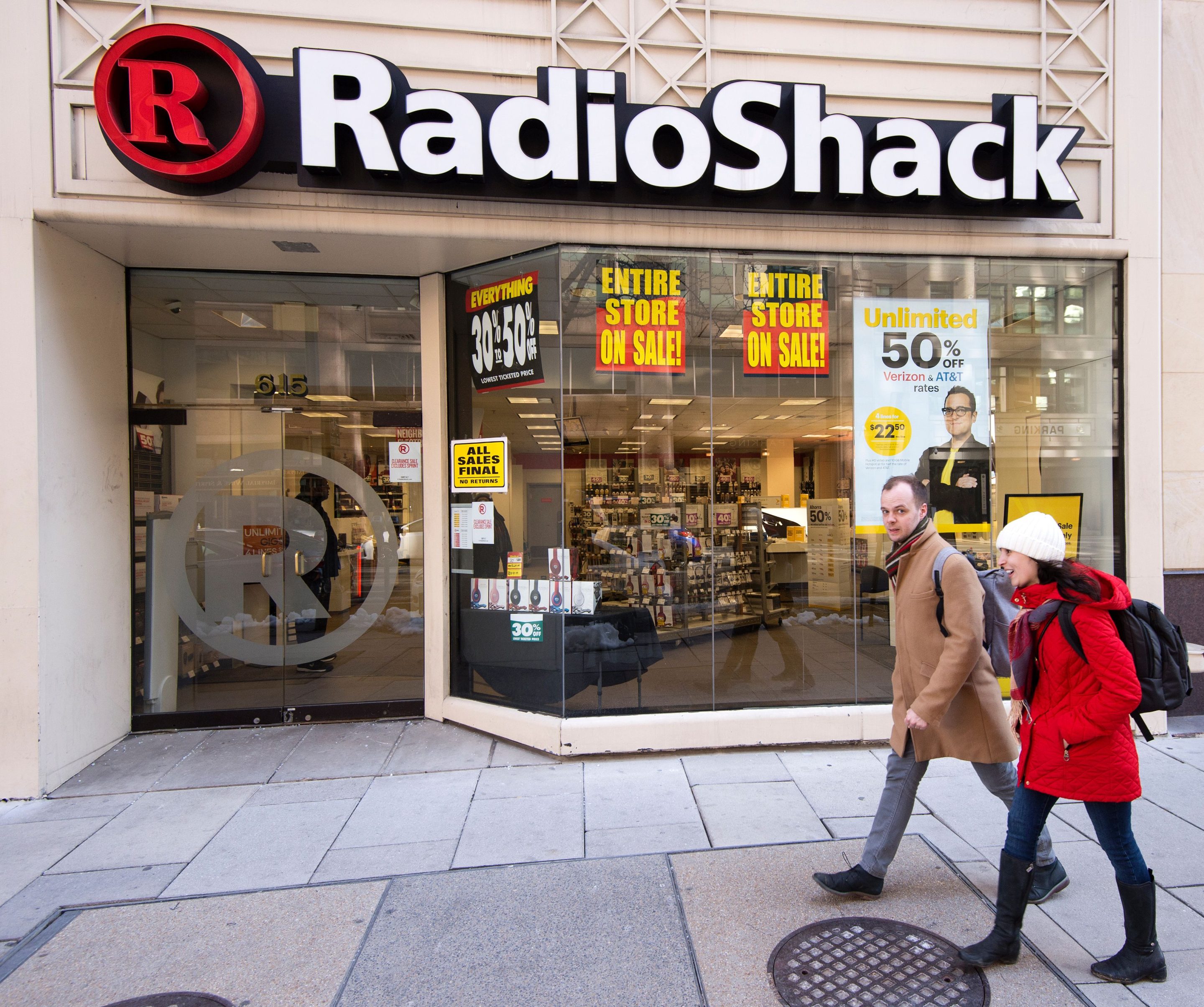 People walk past the Radio Shack in downtown Washington, DC, March 16, 2017.