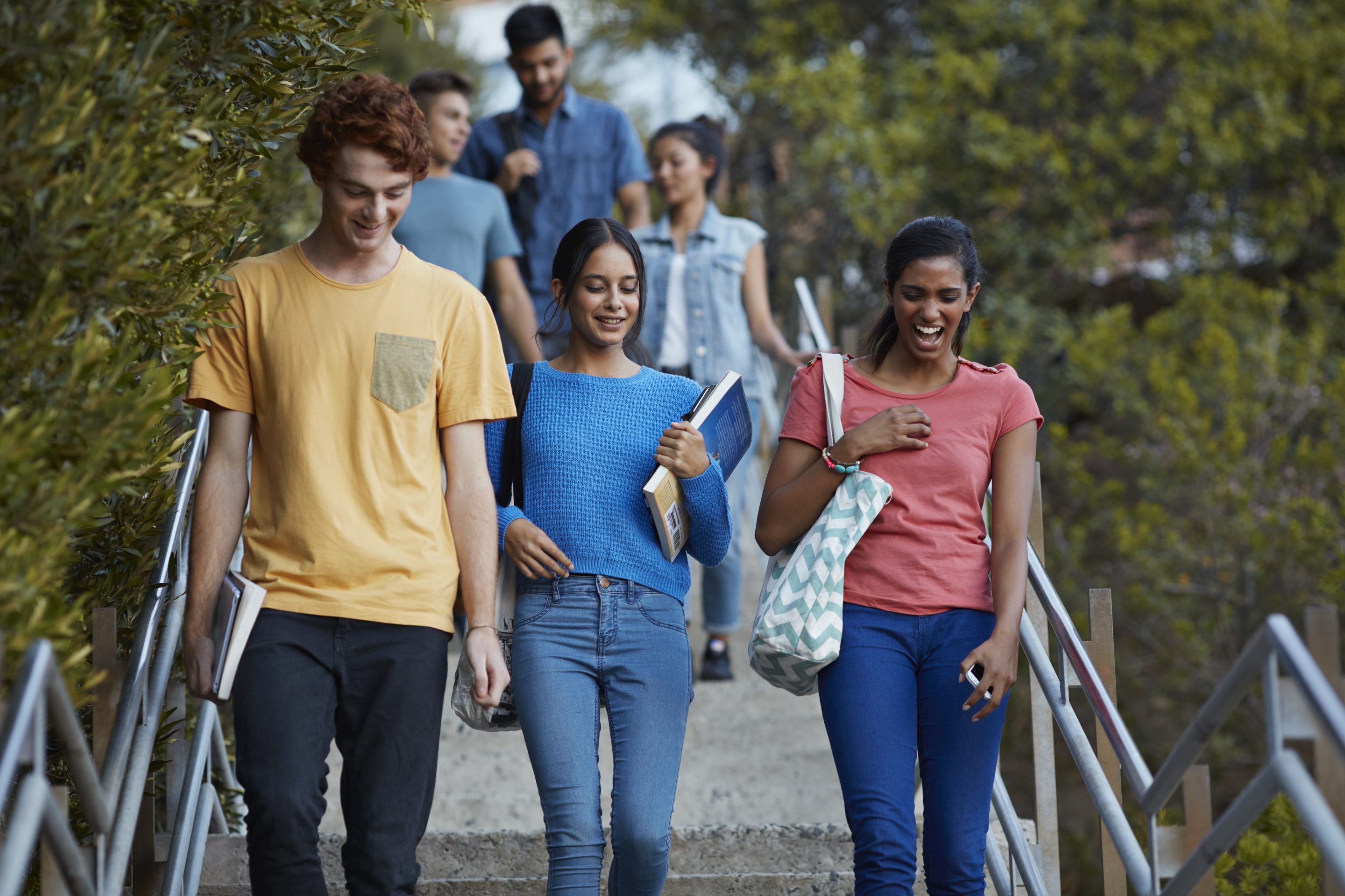 Friends walking down stairs after school