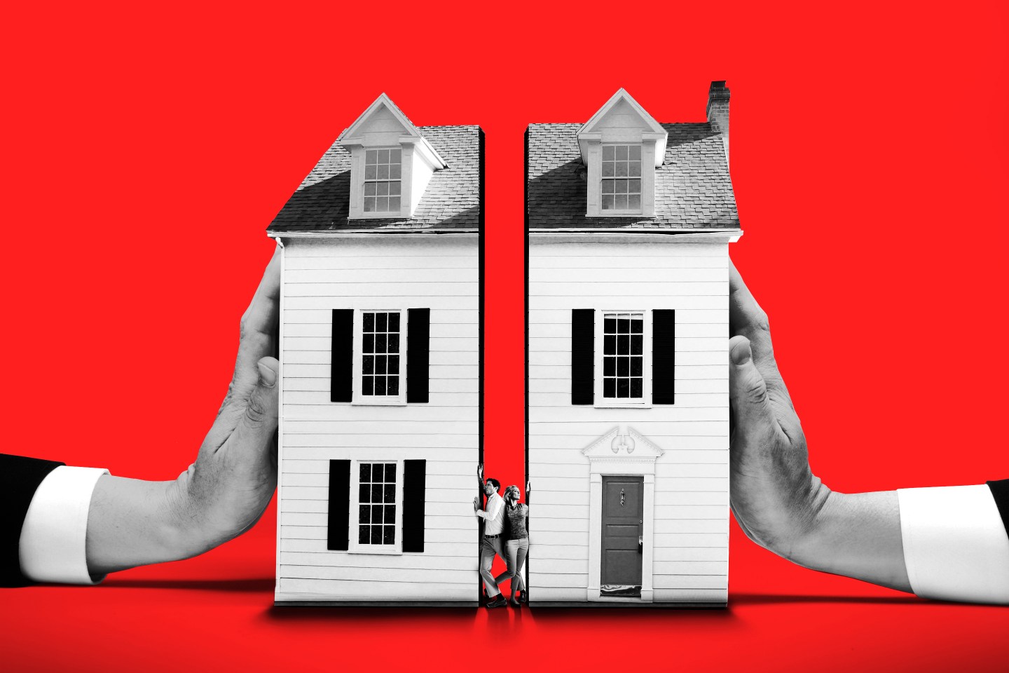 Couple squeezed between houses pushed by large hands