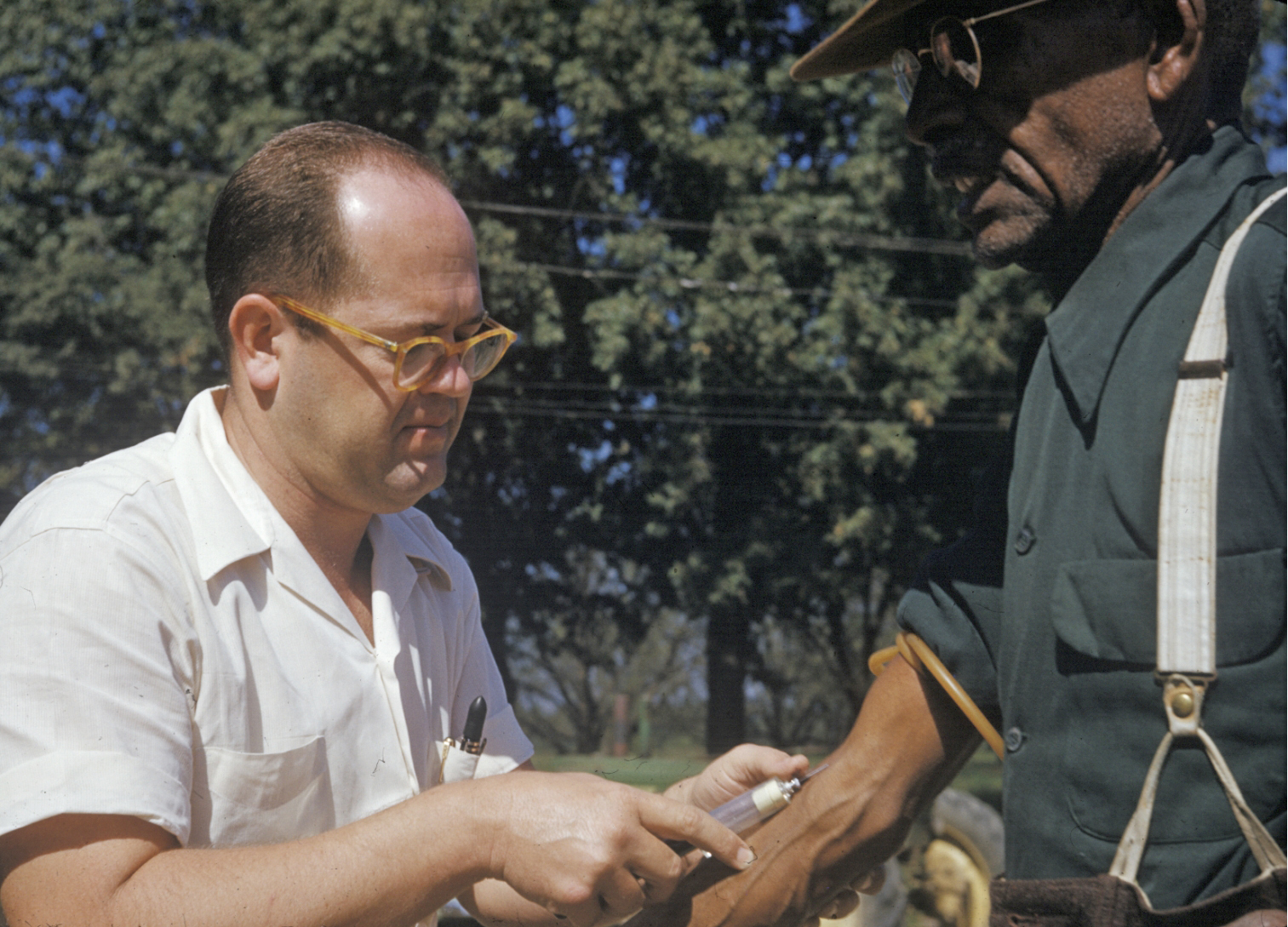 In this 1950's photo released by the National Archives, a Black man included in a syphilis study has blood drawn by a doctor in Tuskegee, Ala. Fifty years after the infamous Tuskegee syphilis study was revealed to the public in 1972 and halted, Manhattan-based philanthropy organization Milbank Memorial Fund is publicly apologizing for its role in the infamous Tuskegee syphilis study.