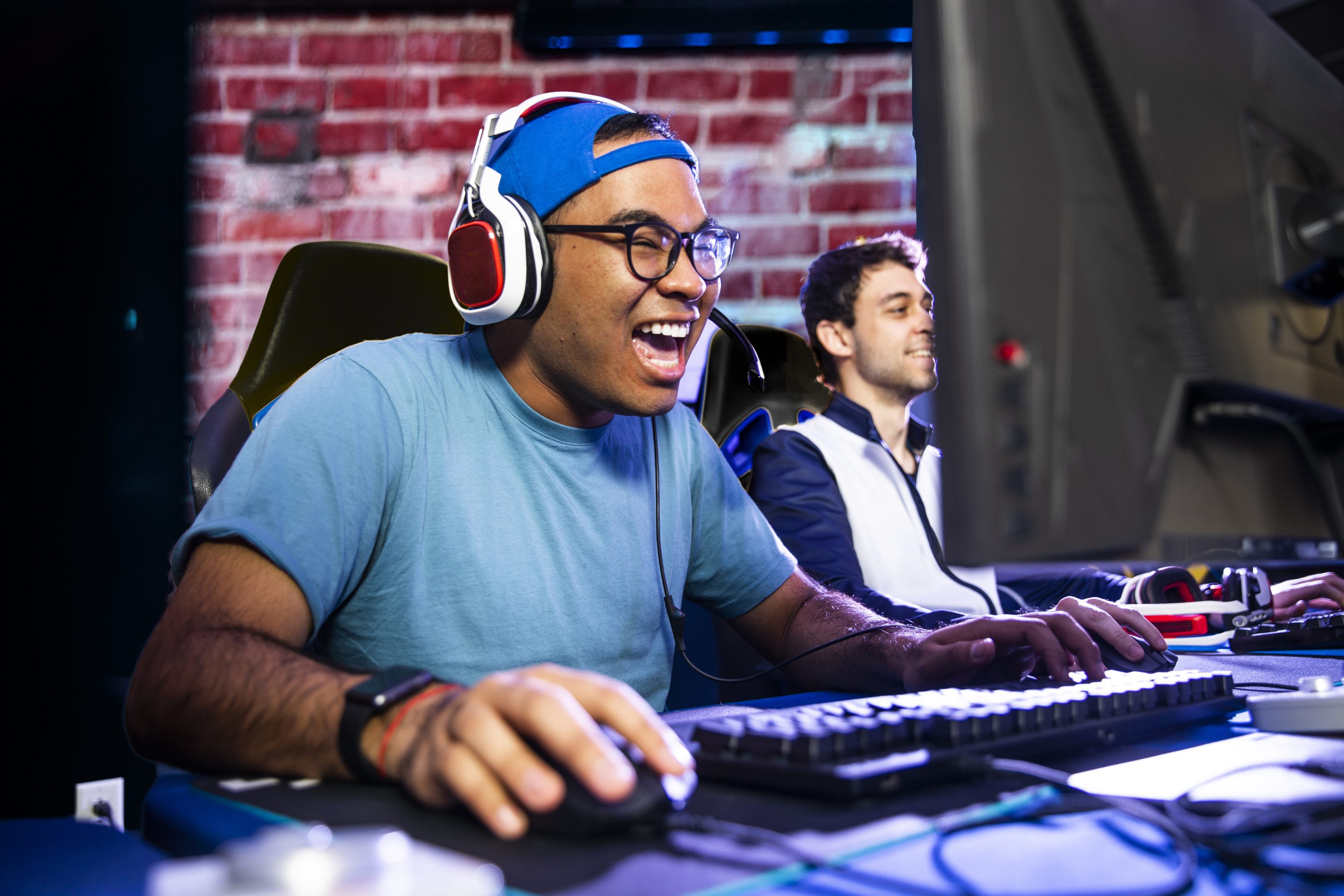 A young Hispanic man gaming with his friends