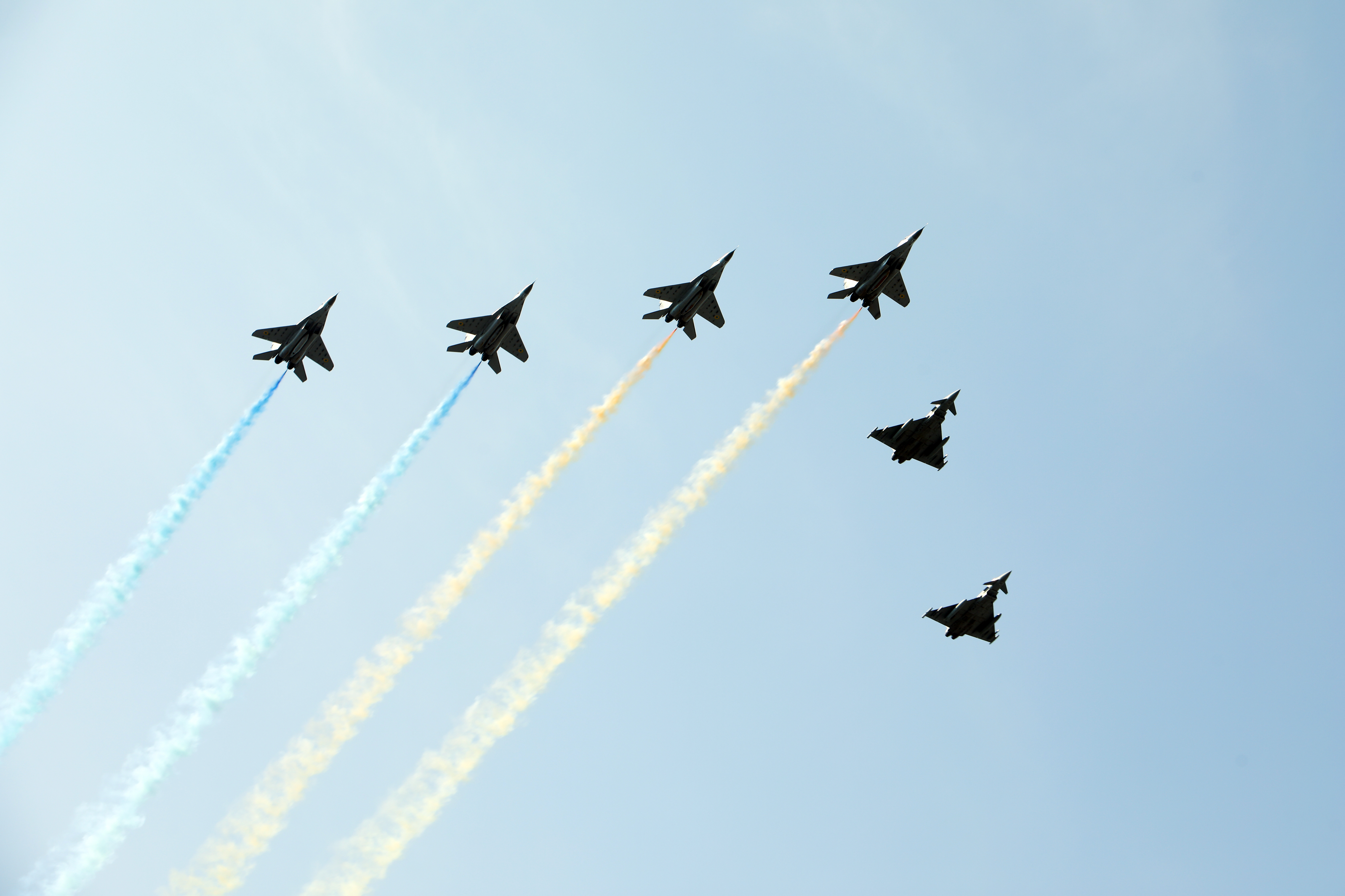 MiG-29 air superiority fighters (L) spread smoke in the colors of the National flag of Ukraine to conclude the solemn military parade on the 30th anniversary of Ukrainian Independence, Kyiv, capital of Ukraine.