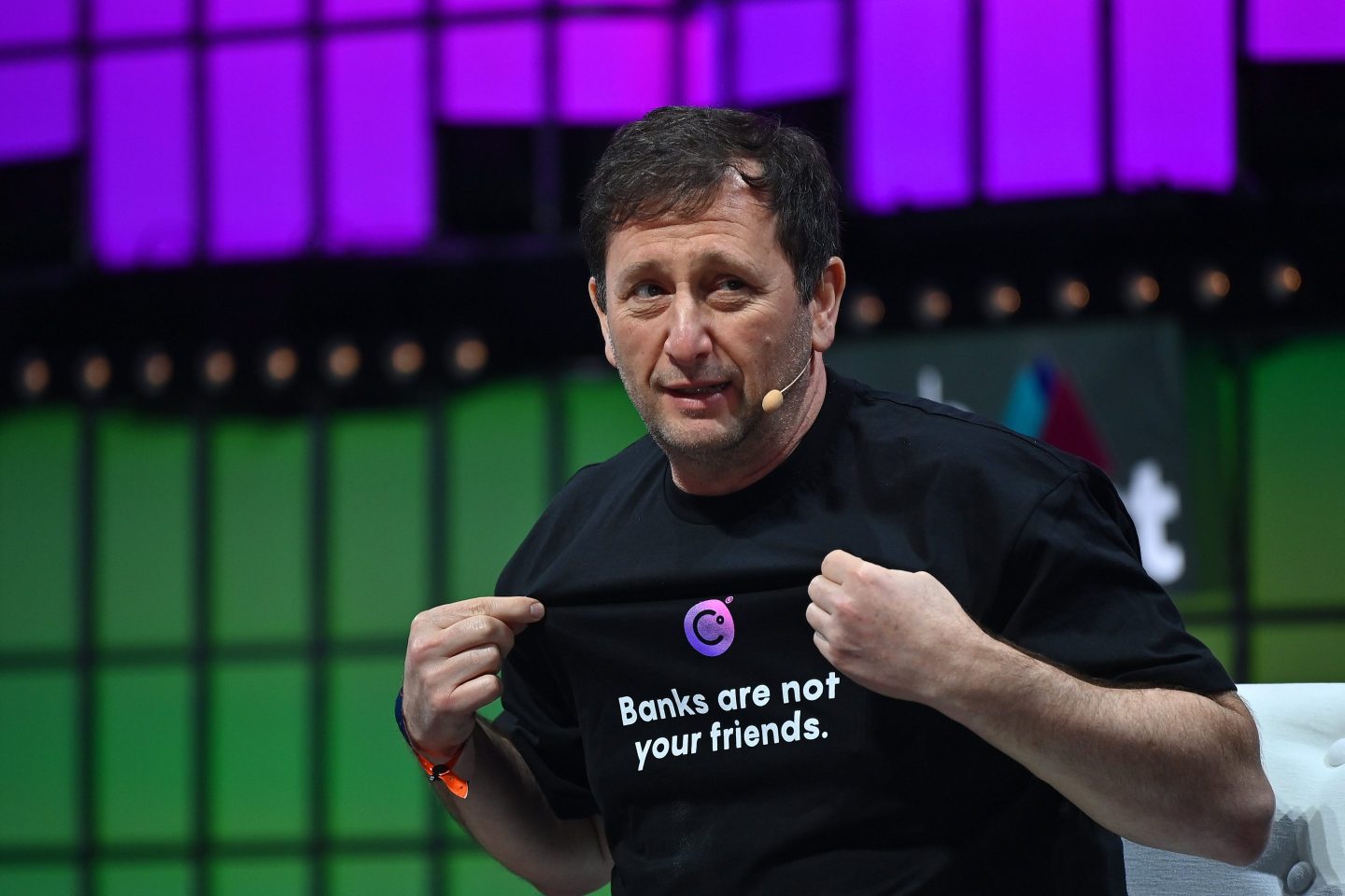 Celsius founder Alex Mashinsky shows off his company t-shirt that says 'banks are not your friends'