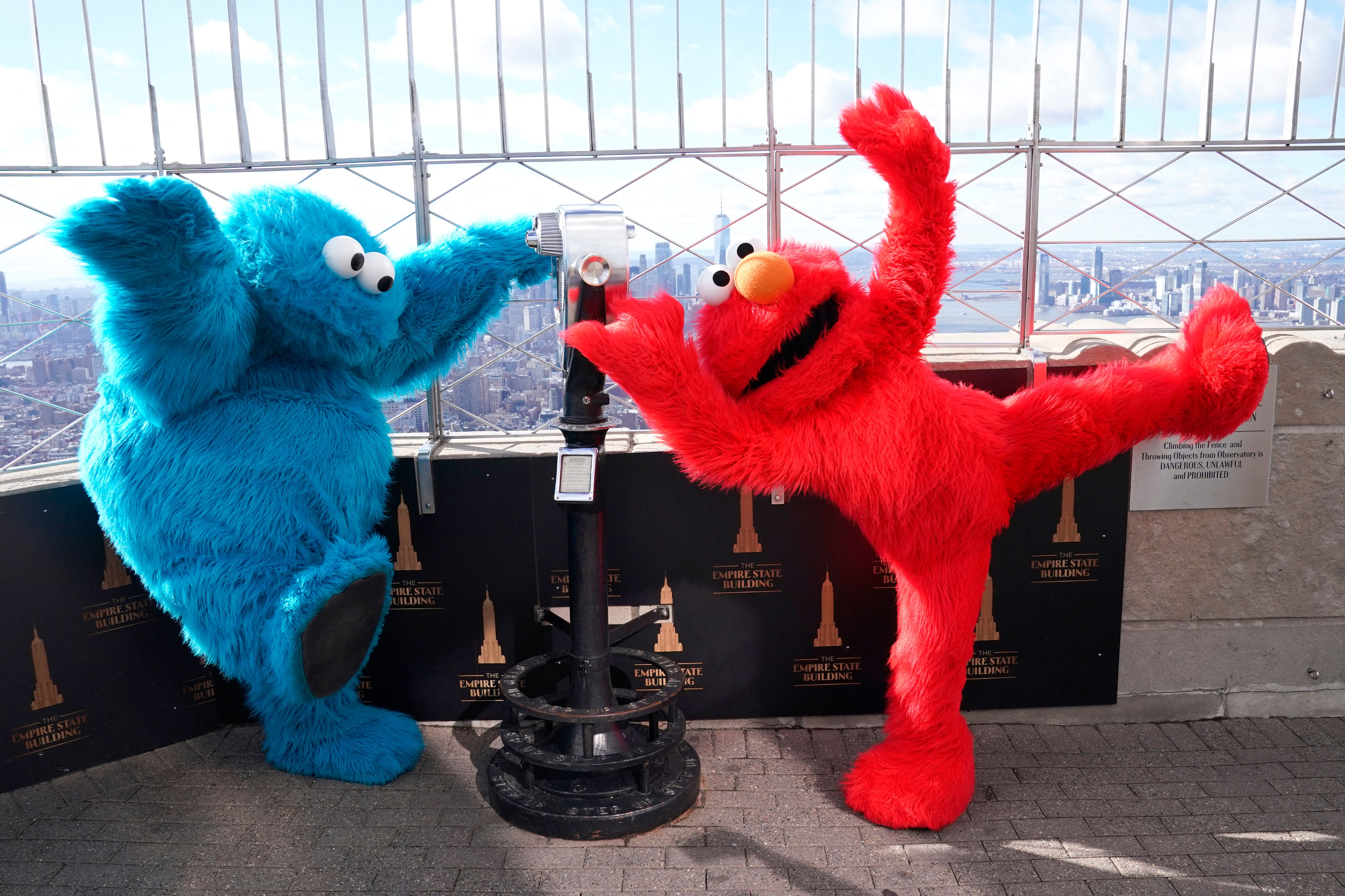 Elmo (right, with Cookie Monster) got vaccinated, and Sen. Ted Cruz isn't pleased.